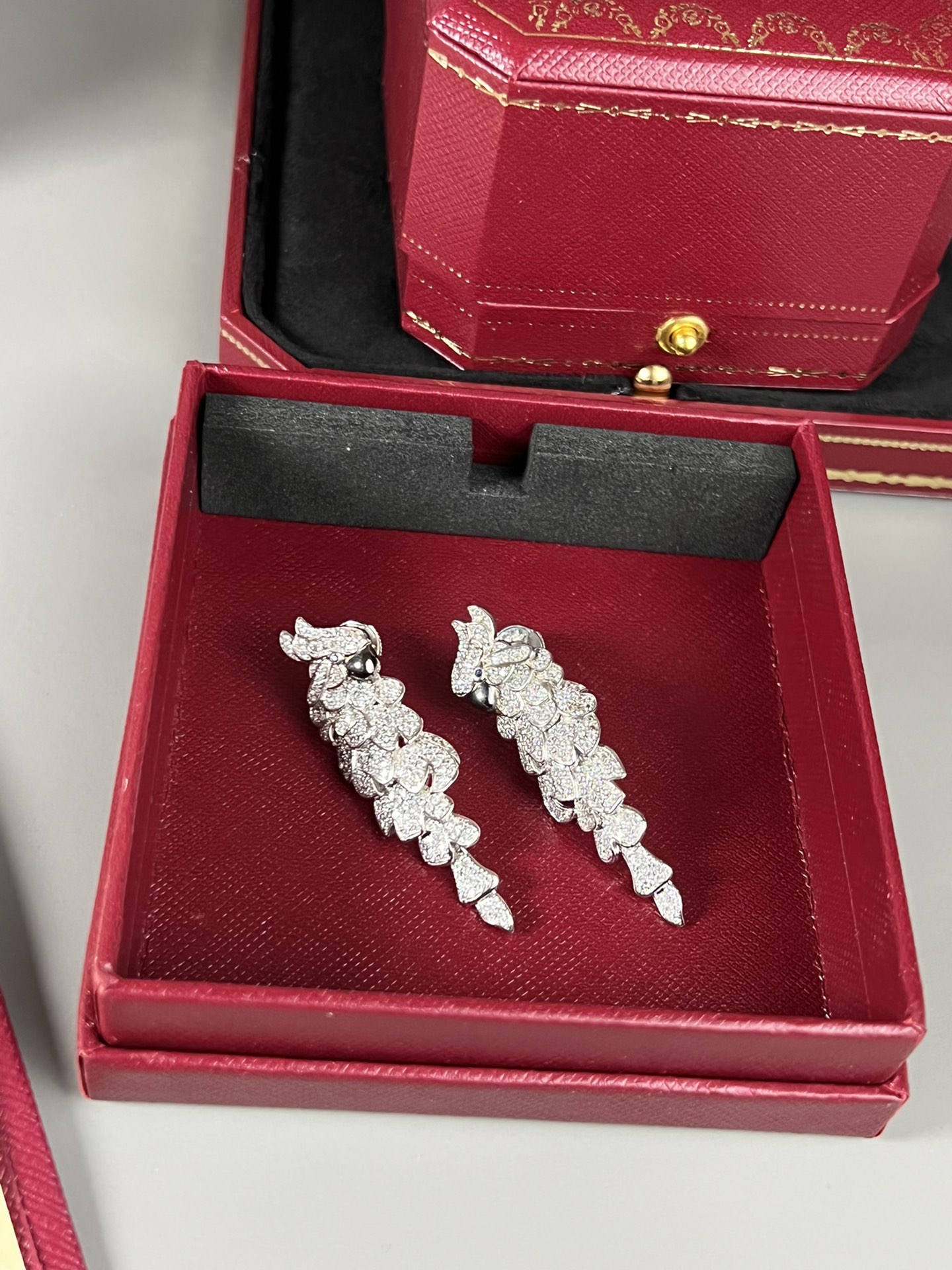 Cartier Les Oiseaux Liberes Parrot earrings 18k white gold pave set white diamonds blue sapphire eyes black rhodium plated beaks 4 8cm length
