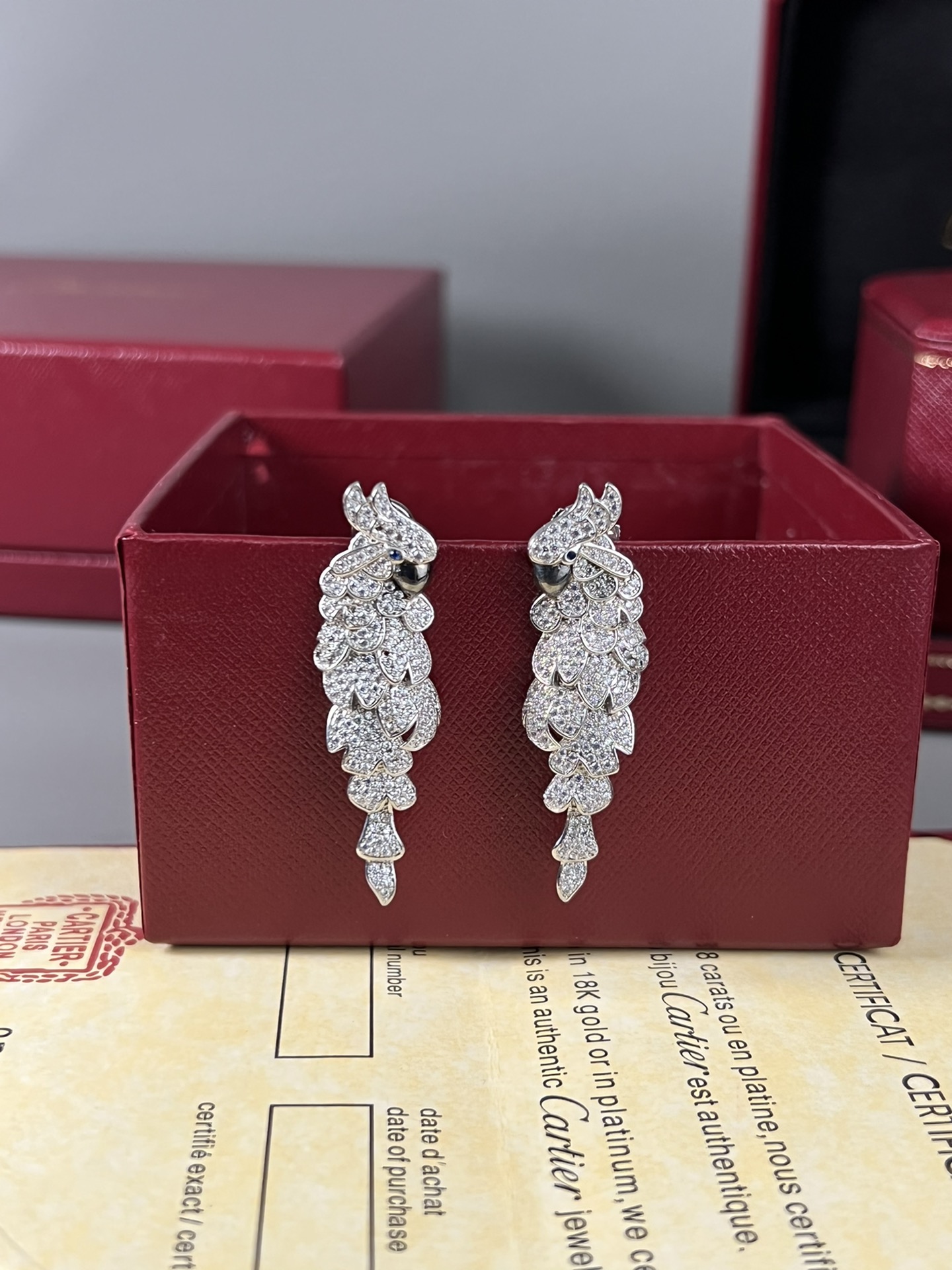 Cartier Les Oiseaux Liberes Parrot earrings 18k white gold pave set white diamonds blue sapphire eyes black rhodium plated beaks 4 8cm length