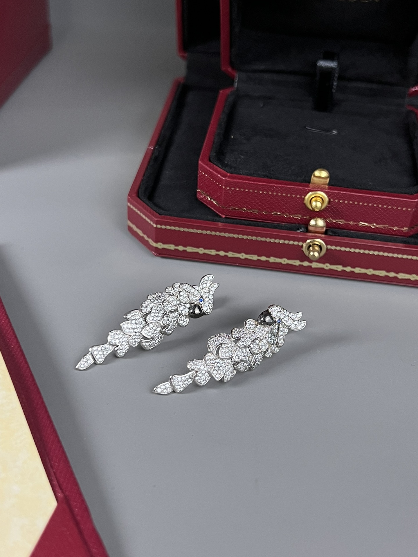 Cartier Les Oiseaux Liberes Parrot earrings 18k white gold pave set white diamonds blue sapphire eyes black rhodium plated beaks 4 8cm length