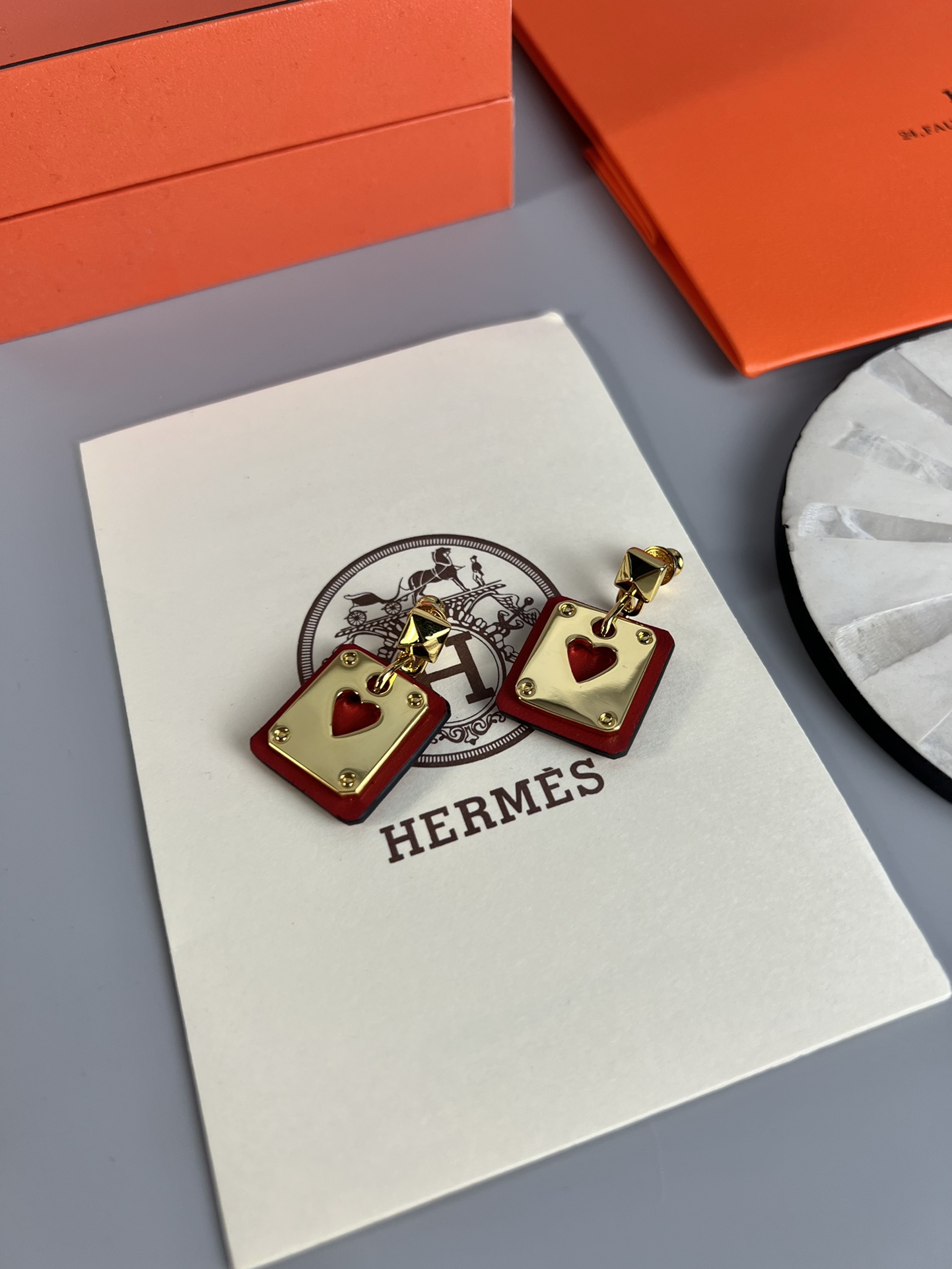 Hermes As de Coeur Swift Heart Stud Earrings earrings Gold-tone metal with black Swift leather black variant Gold-tone metal with red Swift leather red variant black or red heart cutout detail 2cm drop length