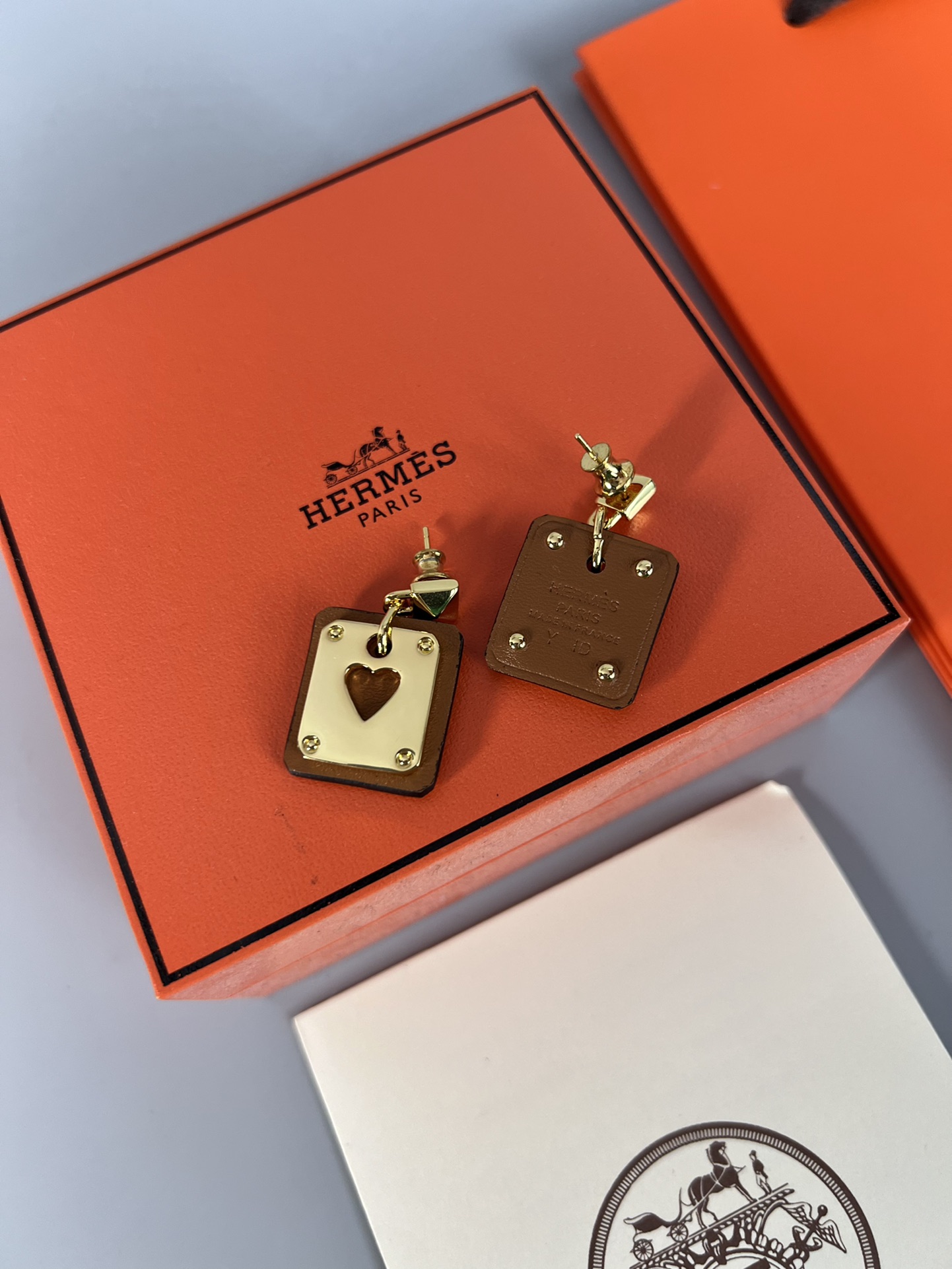 Hermes As de Coeur Swift Heart Stud Earrings earrings Gold-tone metal with black Swift leather black variant Gold-tone metal with red Swift leather red variant black or red heart cutout detail 2cm drop length
