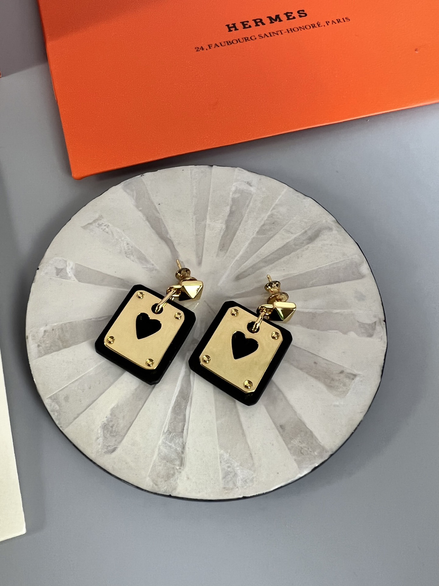 Hermes As de Coeur Swift Heart Stud Earrings earrings Gold-tone metal with black Swift leather black variant Gold-tone metal with red Swift leather red variant black or red heart cutout detail 2cm drop length