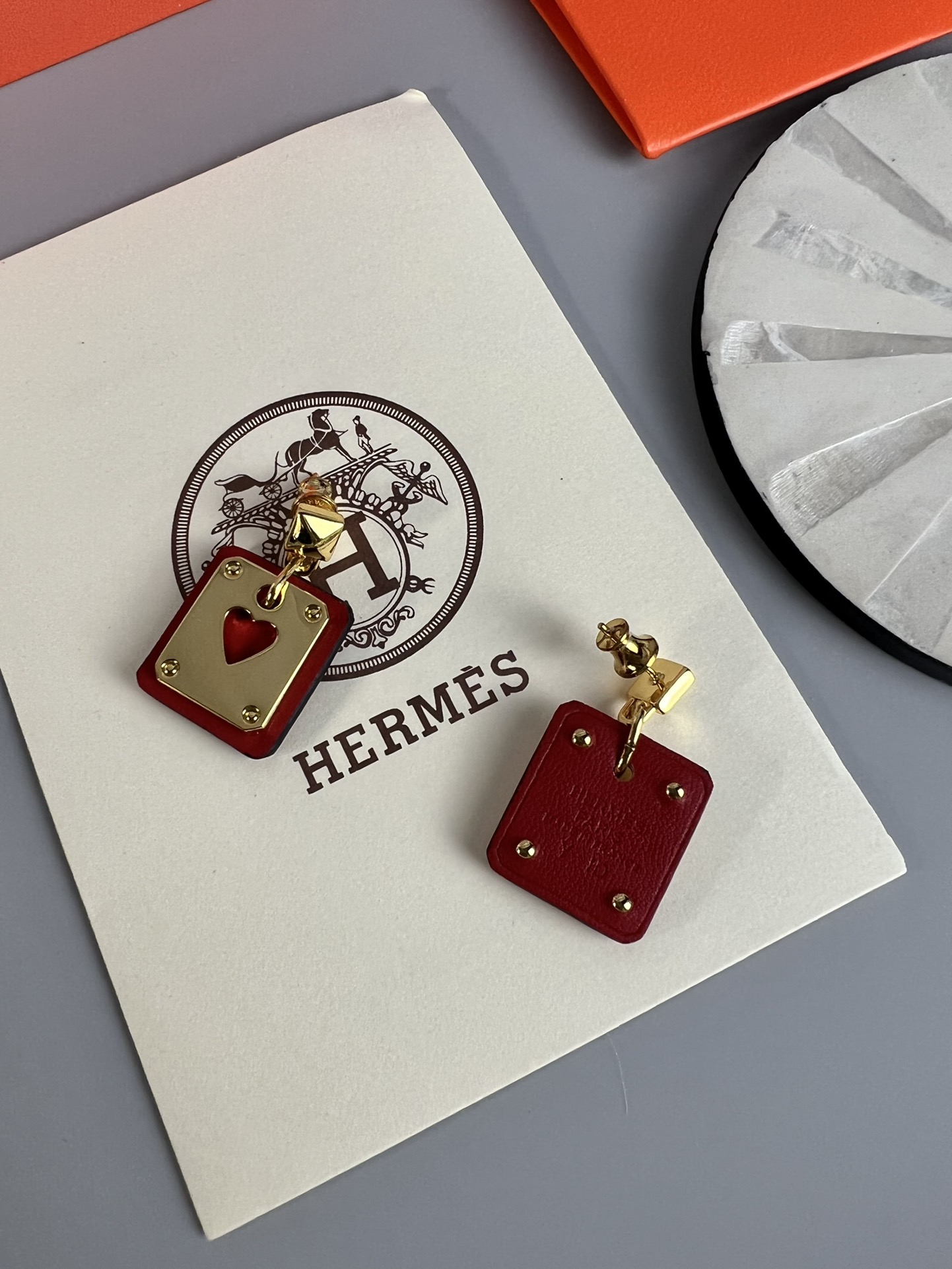Hermes As de Coeur Swift Heart Stud Earrings earrings Gold-tone metal with black Swift leather black variant Gold-tone metal with red Swift leather red variant black or red heart cutout detail 2cm drop length