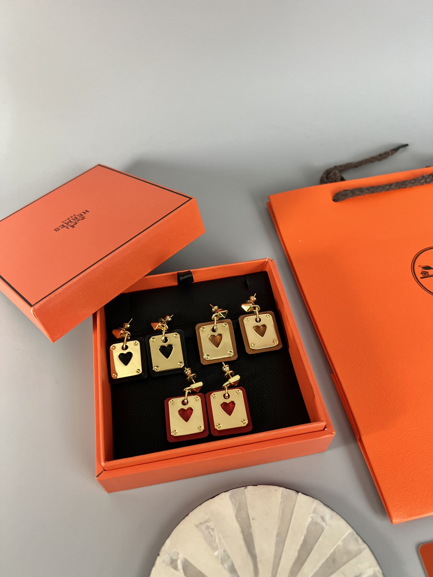 Hermes As de Coeur Swift Heart Stud Earrings earrings Gold-tone metal with black Swift leather black variant Gold-tone metal with red Swift leather red variant black or red heart cutout detail 2cm drop length