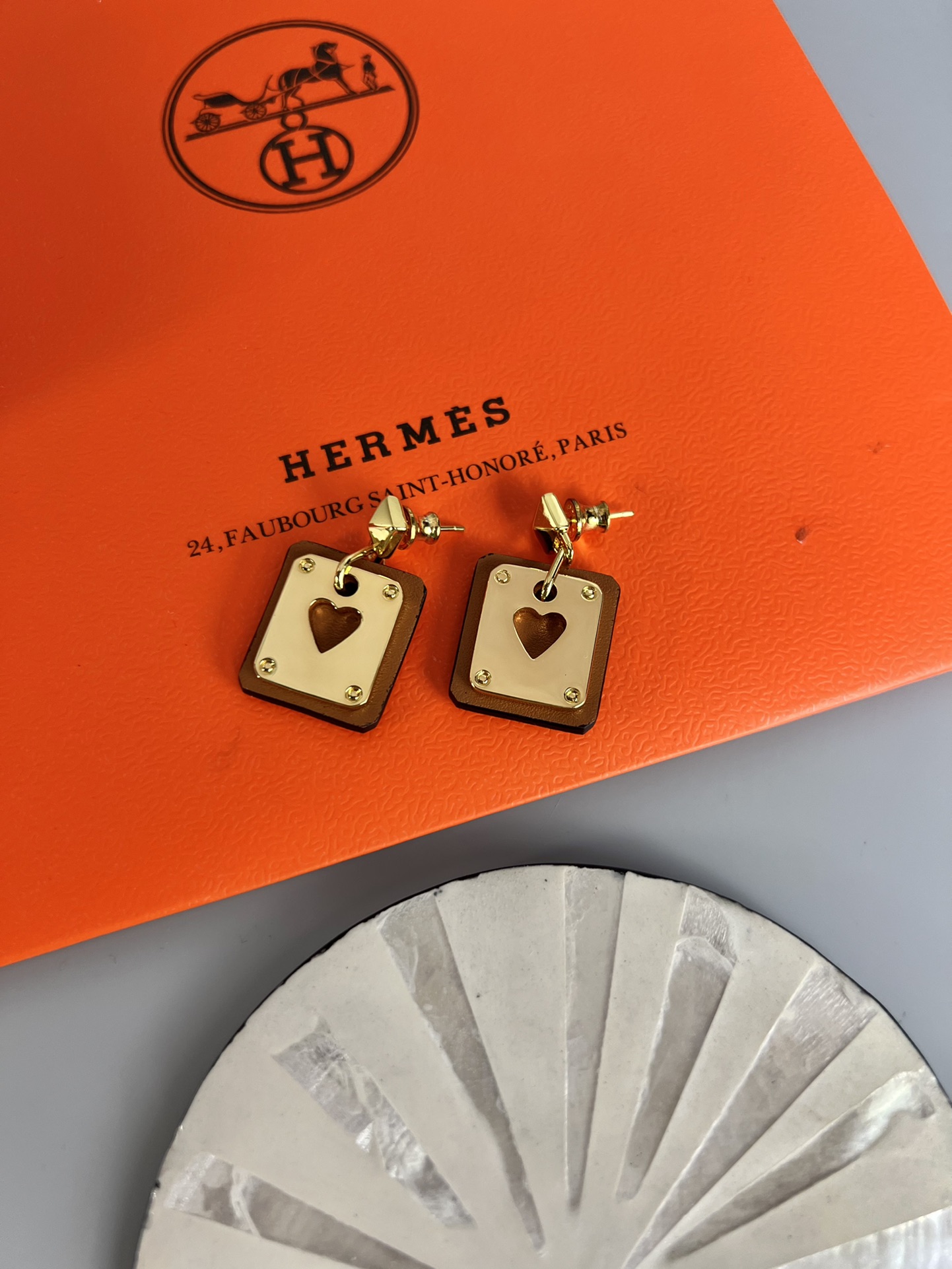Hermes As de Coeur Swift Heart Stud Earrings earrings Gold-tone metal with black Swift leather black variant Gold-tone metal with red Swift leather red variant black or red heart cutout detail 2cm drop length