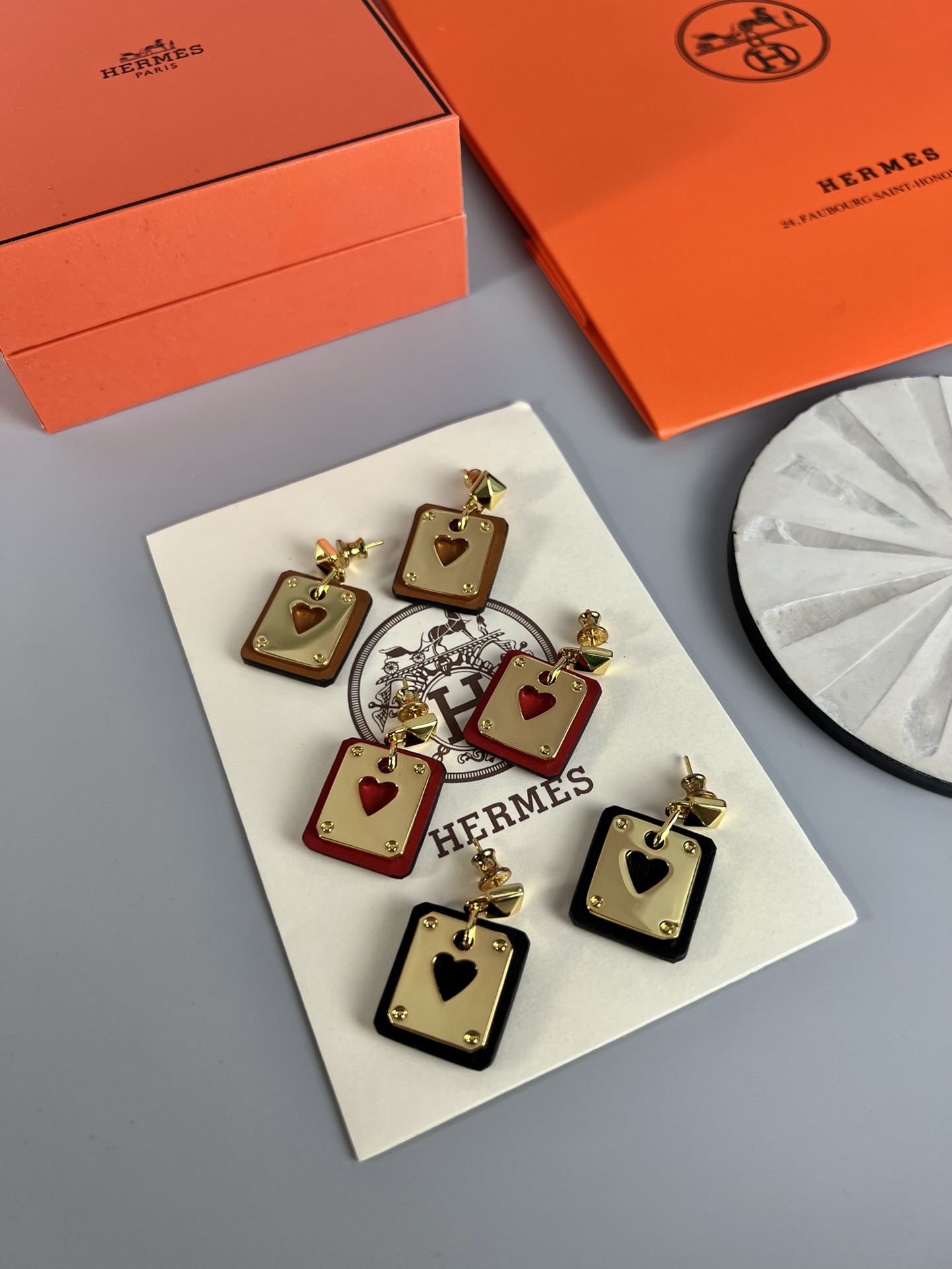 Hermes As de Coeur Swift Heart Stud Earrings earrings Gold-tone metal with black Swift leather black variant Gold-tone metal with red Swift leather red variant black or red heart cutout detail 2cm drop length