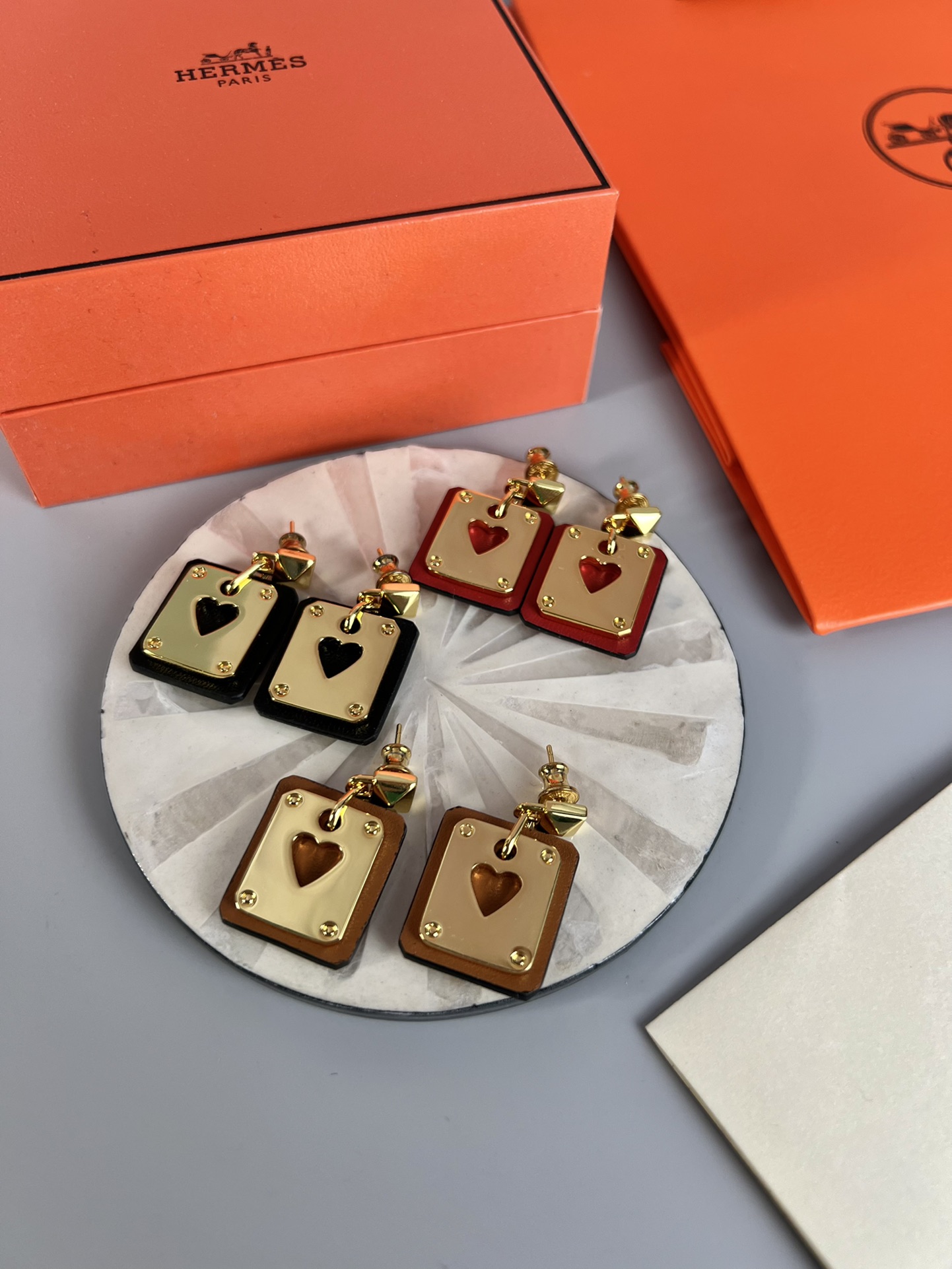 Hermes As de Coeur Swift Heart Stud Earrings earrings Gold-tone metal with black Swift leather black variant Gold-tone metal with red Swift leather red variant black or red heart cutout detail 2cm drop length