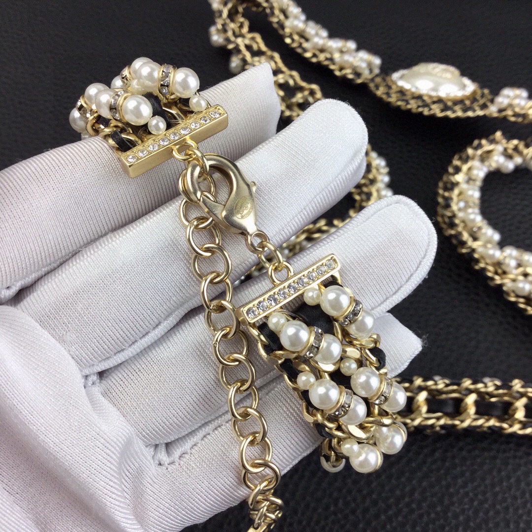 Chanel CC Logo Pearl Chain Medallion necklace gold-tone metal cream white faux pearls clear crystal rhinestones black leather chain accents 42cm with 5cm extender
