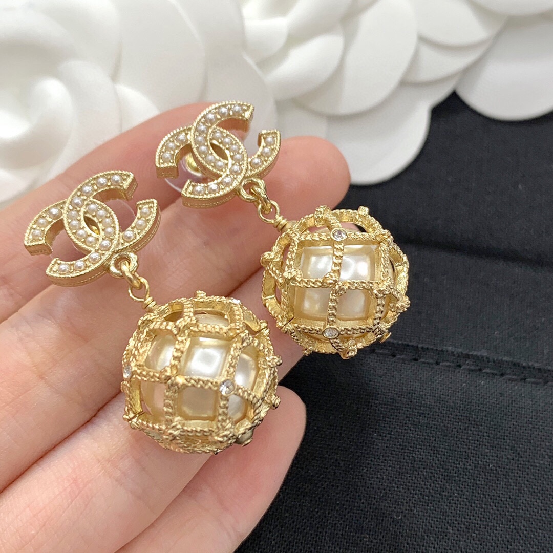 Chanel CC Logo Caged Pearl Drop Earrings earrings Gold-tone metal with cream faux pearls and clear crystal accents Drop length approximately 3cm