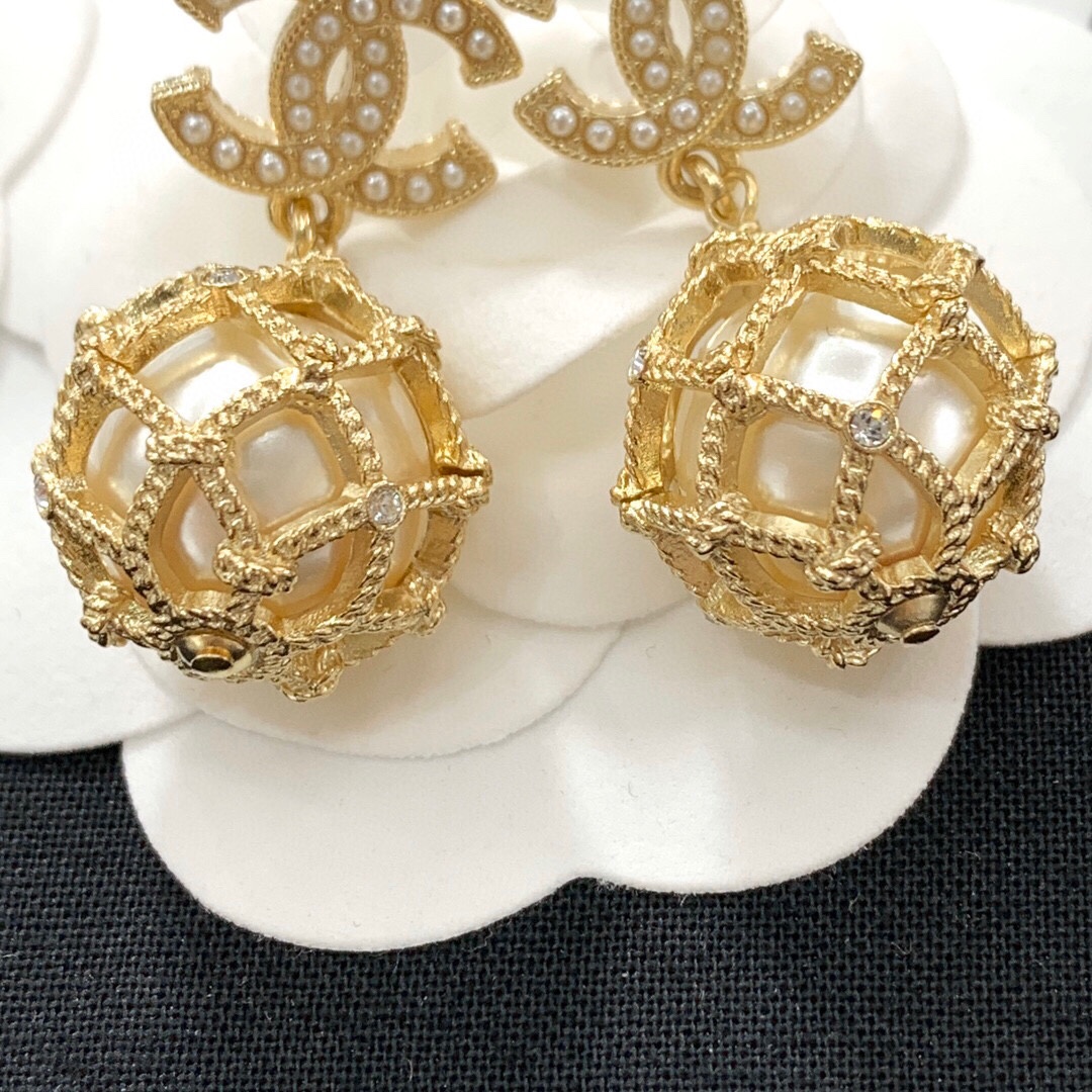 Chanel CC Logo Caged Pearl Drop Earrings earrings Gold-tone metal with cream faux pearls and clear crystal accents Drop length approximately 3cm