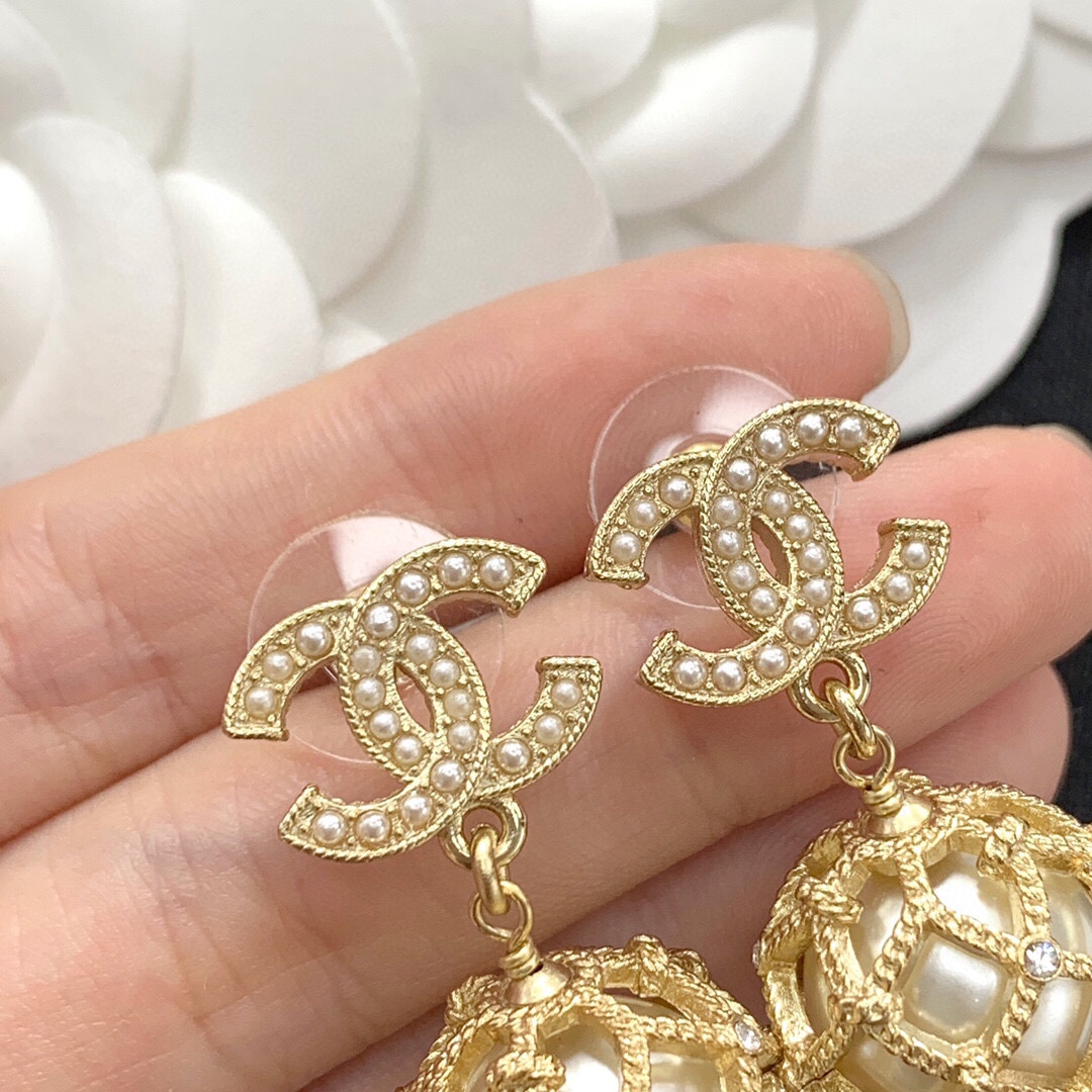 Chanel CC Logo Caged Pearl Drop Earrings earrings Gold-tone metal with cream faux pearls and clear crystal accents Drop length approximately 3cm