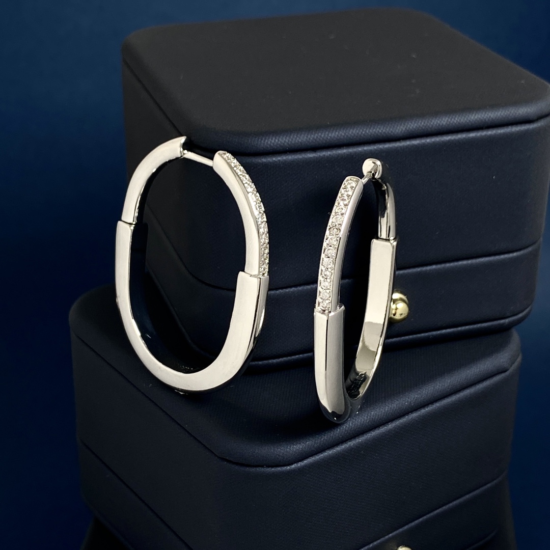 Tiffany Lock Hoop Earrings earrings Yellow gold with clear diamond accents available in white gold and rose gold variants 25mm hoop diameter
