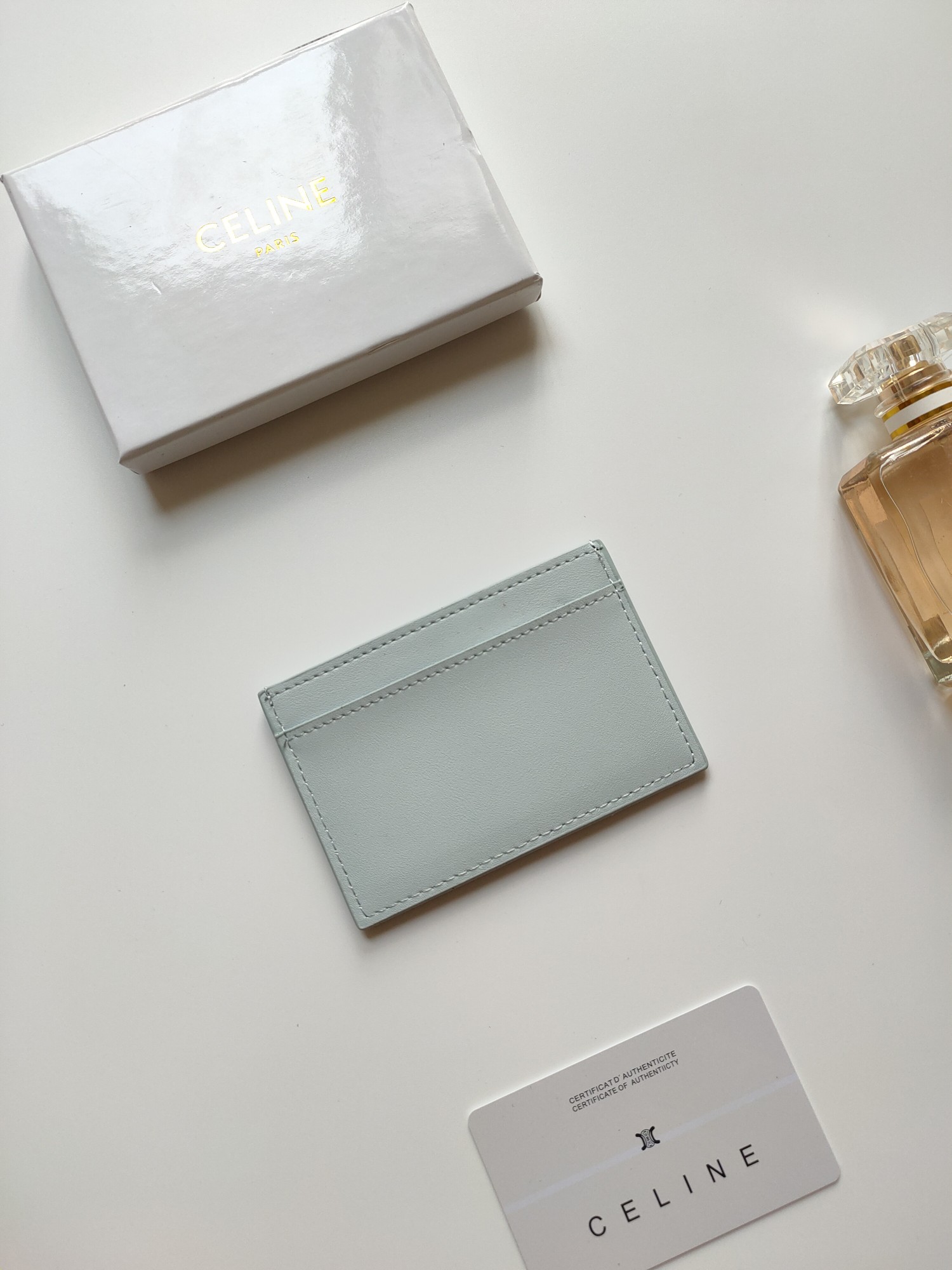 Celine Triomphe card holder pale ice blue smooth leather matching tone-on-tone embossed Triomphe logo light contrast stitching 10 5 x 7cm