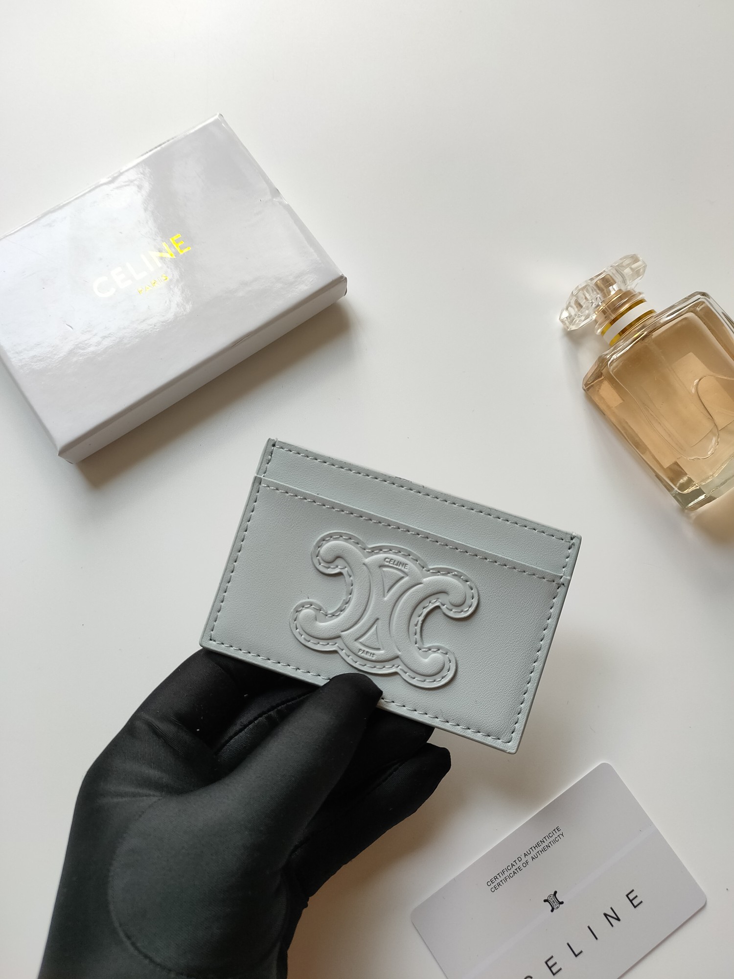 Celine Triomphe card holder pale ice blue smooth leather matching tone-on-tone embossed Triomphe logo light contrast stitching 10 5 x 7cm