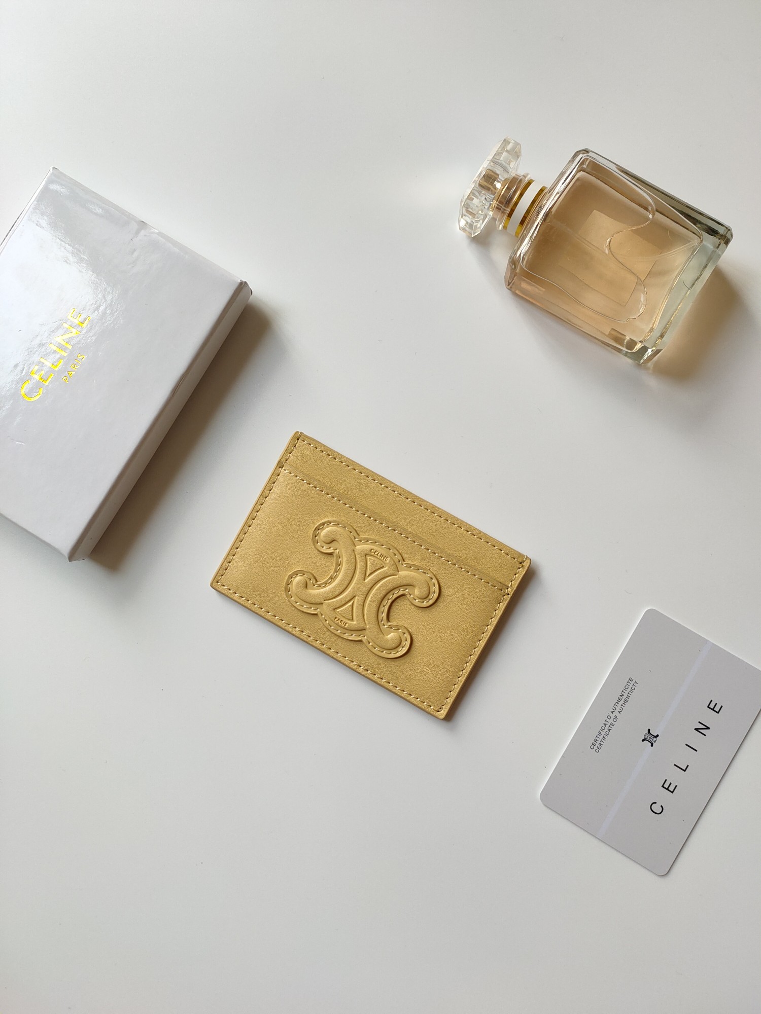 Celine Triomphe card holder pastel yellow smooth leather with matching tone embossed Triomphe logo 10 5 x 7cm