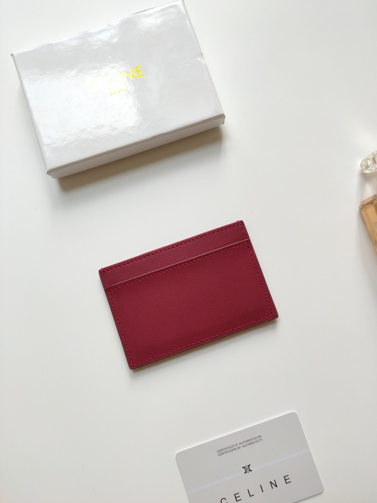 Celine Triomphe card holder Burgundy smooth calfskin leather with matching tone Triomphe logo embossment 7cm x 10 5cm