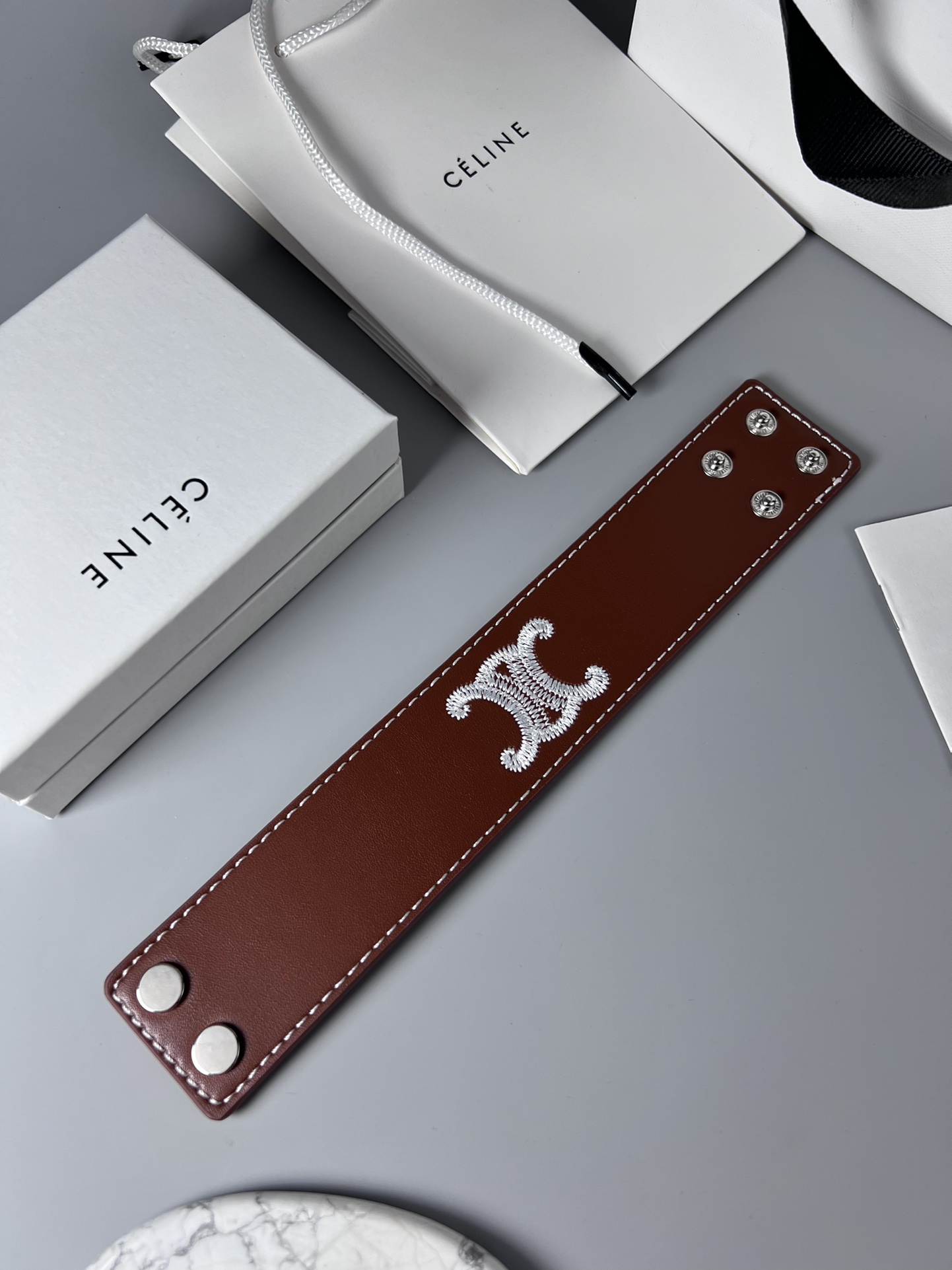 Celine Triomphe Embroidered Wide Leather Cuff bracelet burgundy brown smooth calfskin leather white contrast stitching silver-tone embroidered Triomphe logo silver-tone metal snap hardware adjustable snap closure 4cm width