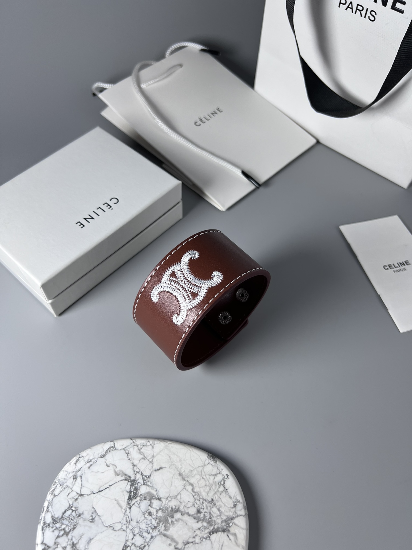 Celine Triomphe Embroidered Wide Leather Cuff bracelet burgundy brown smooth calfskin leather white contrast stitching silver-tone embroidered Triomphe logo silver-tone metal snap hardware adjustable snap closure 4cm width