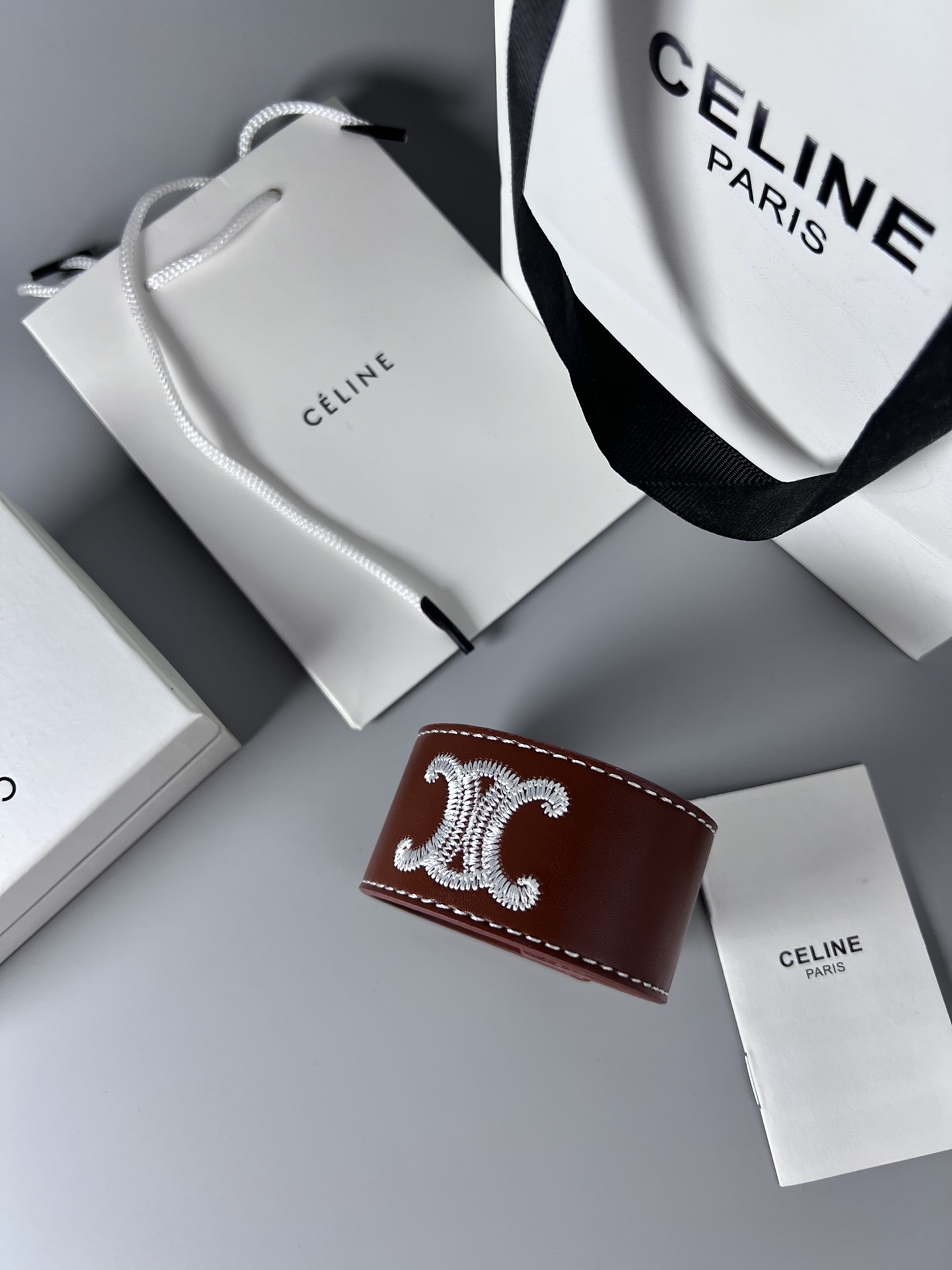 Celine Triomphe Embroidered Wide Leather Cuff bracelet burgundy brown smooth calfskin leather white contrast stitching silver-tone embroidered Triomphe logo silver-tone metal snap hardware adjustable snap closure 4cm width