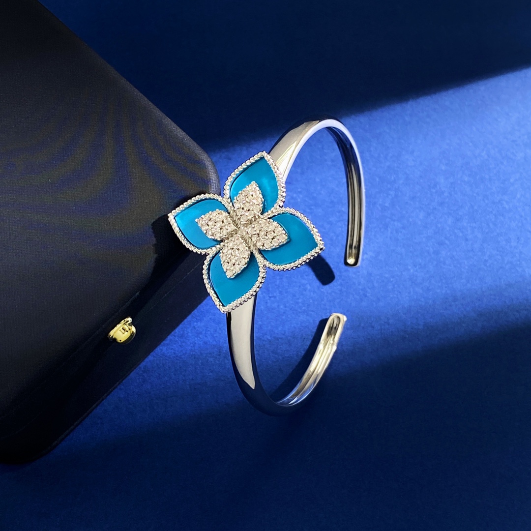 Van Cleef Arpels RC80 bracelet silver-toned metal with diamond-paved flower centers available with green malachite white mother-of-pearl black onyx turquoise blue and dark blue lapis lazuli petal inlays 17cm