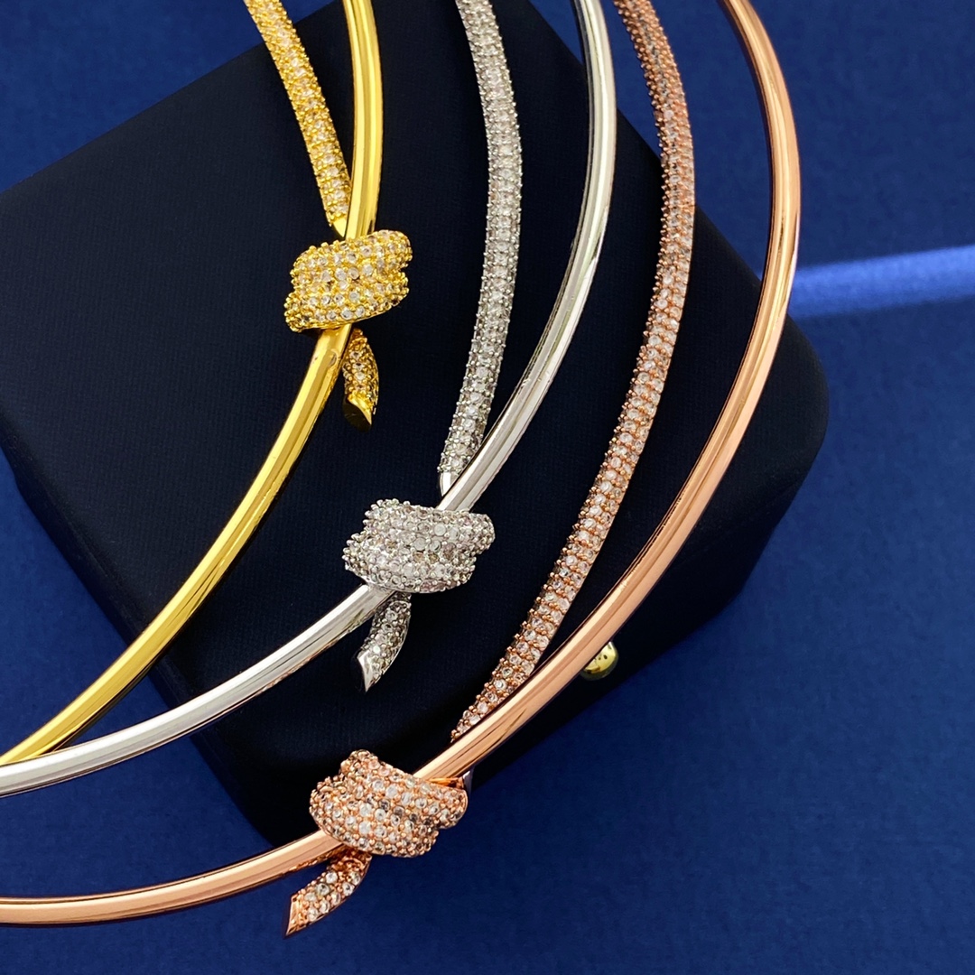 Tiffany Knot necklace silver-toned metal with clear pave stones rose gold-toned metal with clear pave stones yellow gold-toned metal with clear pave stones 16 inches with 2 inch extender