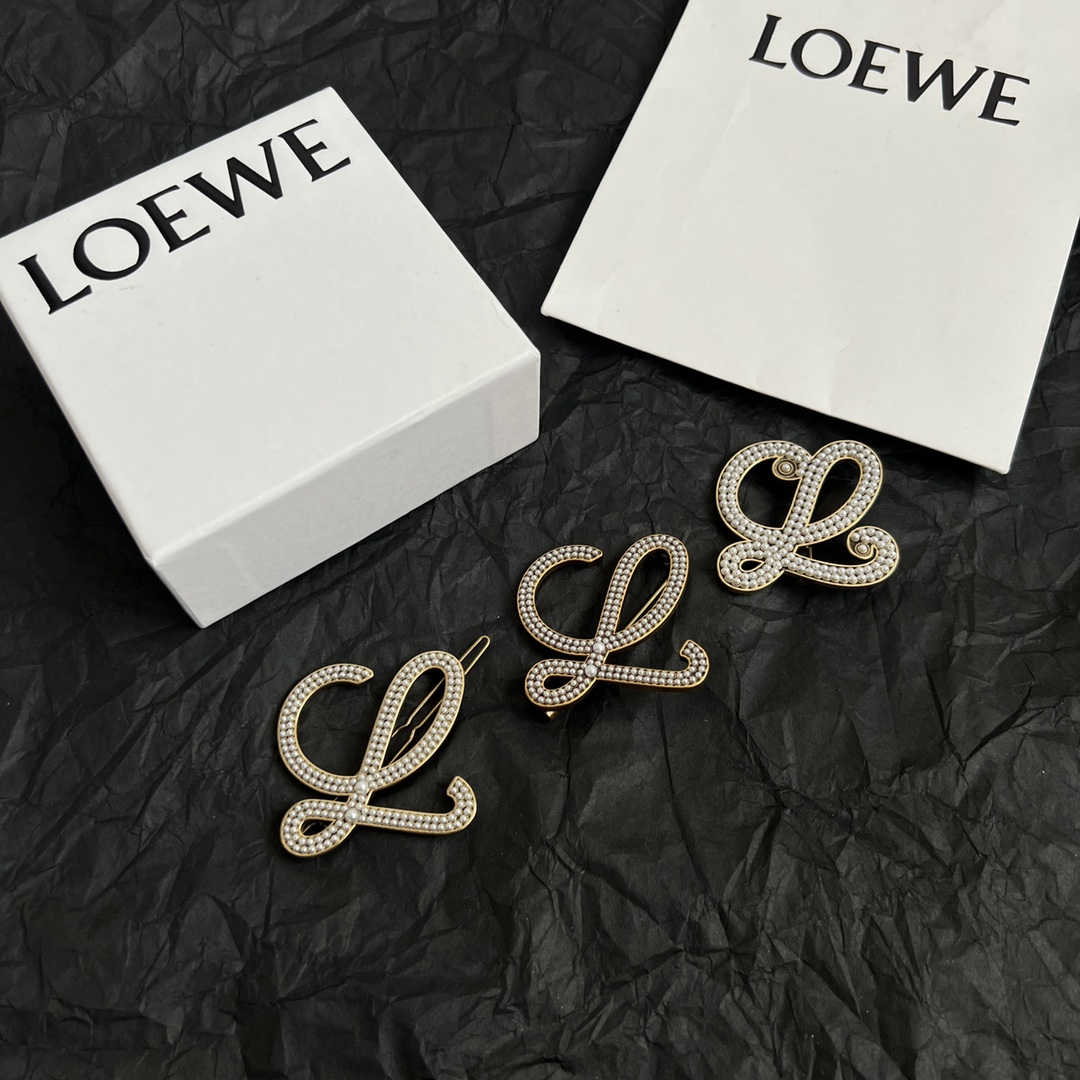 Loewe Anagram brooch antique gold tone metal with white faux pearl embellishments 4 5cm width