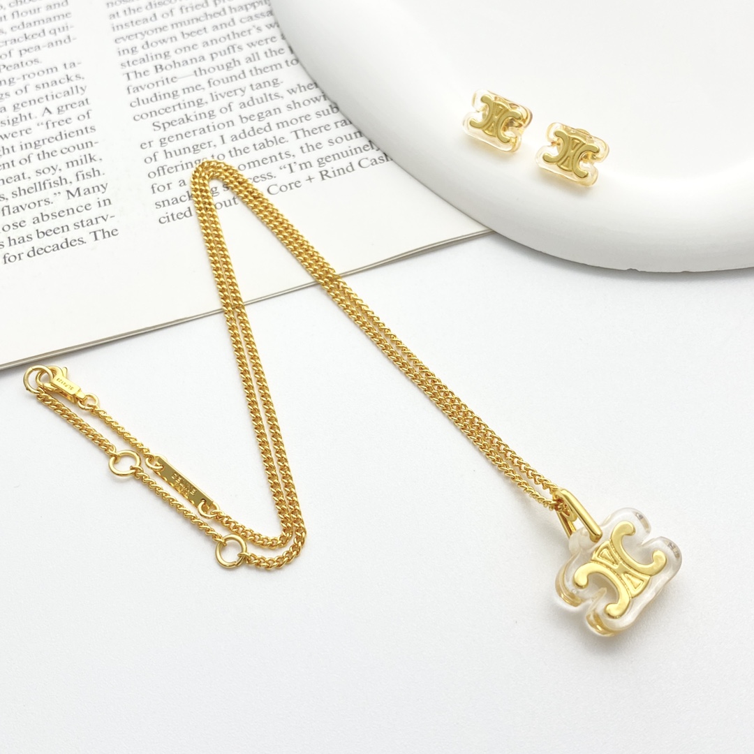 Celine Triomphe earrings gold-tone metal with clear transparent resin 1cm stud diameter