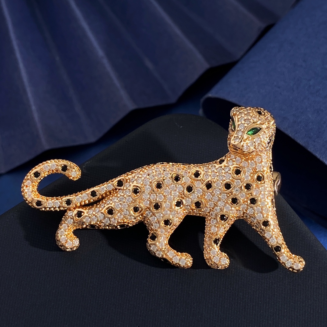 Cartier Panthere de Cartier brooch Silver-toned metal with clear pave stones black spot accents green stone eyes Gold-toned metal with clear pave stones black spot accents green stone eyes Rose gold-toned metal with clear pave stones black spot accents green stone eyes 4 5cm length