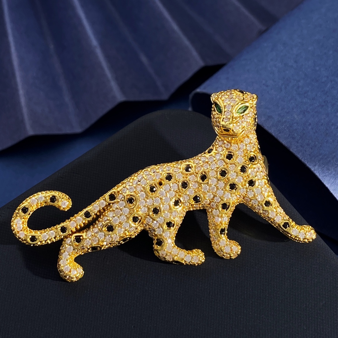 Cartier Panthere de Cartier brooch Silver-toned metal with clear pave stones black spot accents green stone eyes Gold-toned metal with clear pave stones black spot accents green stone eyes Rose gold-toned metal with clear pave stones black spot accents green stone eyes 4 5cm length