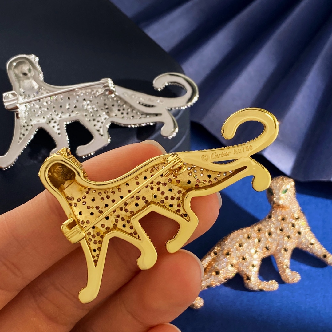 Cartier Panthere de Cartier brooch Silver-toned metal with clear pave stones black spot accents green stone eyes Gold-toned metal with clear pave stones black spot accents green stone eyes Rose gold-toned metal with clear pave stones black spot accents green stone eyes 4 5cm length