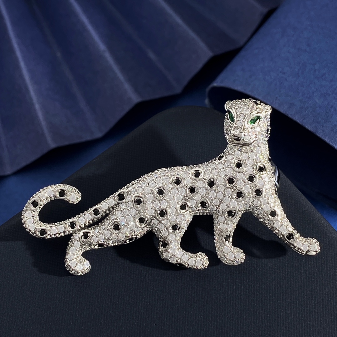Cartier Panthere de Cartier brooch Silver-toned metal with clear pave stones black spot accents green stone eyes Gold-toned metal with clear pave stones black spot accents green stone eyes Rose gold-toned metal with clear pave stones black spot accents green stone eyes 4 5cm length