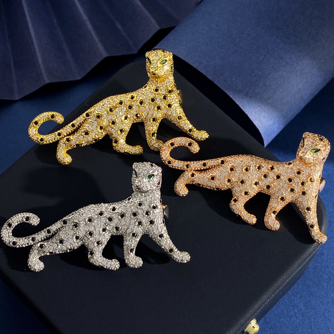 Cartier Panthere de Cartier brooch Silver-toned metal with clear pave stones black spot accents green stone eyes Gold-toned metal with clear pave stones black spot accents green stone eyes Rose gold-toned metal with clear pave stones black spot accents green stone eyes 4 5cm length