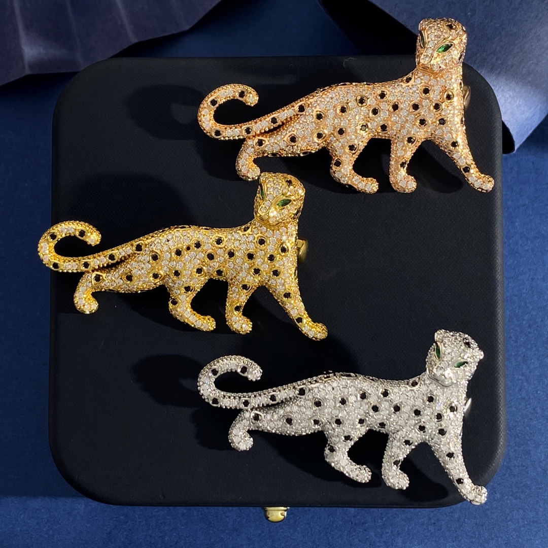Cartier Panthere de Cartier brooch Silver-toned metal with clear pave stones black spot accents green stone eyes Gold-toned metal with clear pave stones black spot accents green stone eyes Rose gold-toned metal with clear pave stones black spot accents green stone eyes 4 5cm length