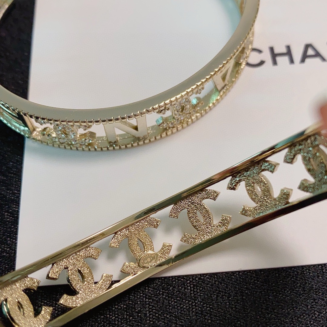 Chanel CC Logo Crystal Cutout Cuff bracelet gold-tone metal with clear crystal accents 17cm inner circumference