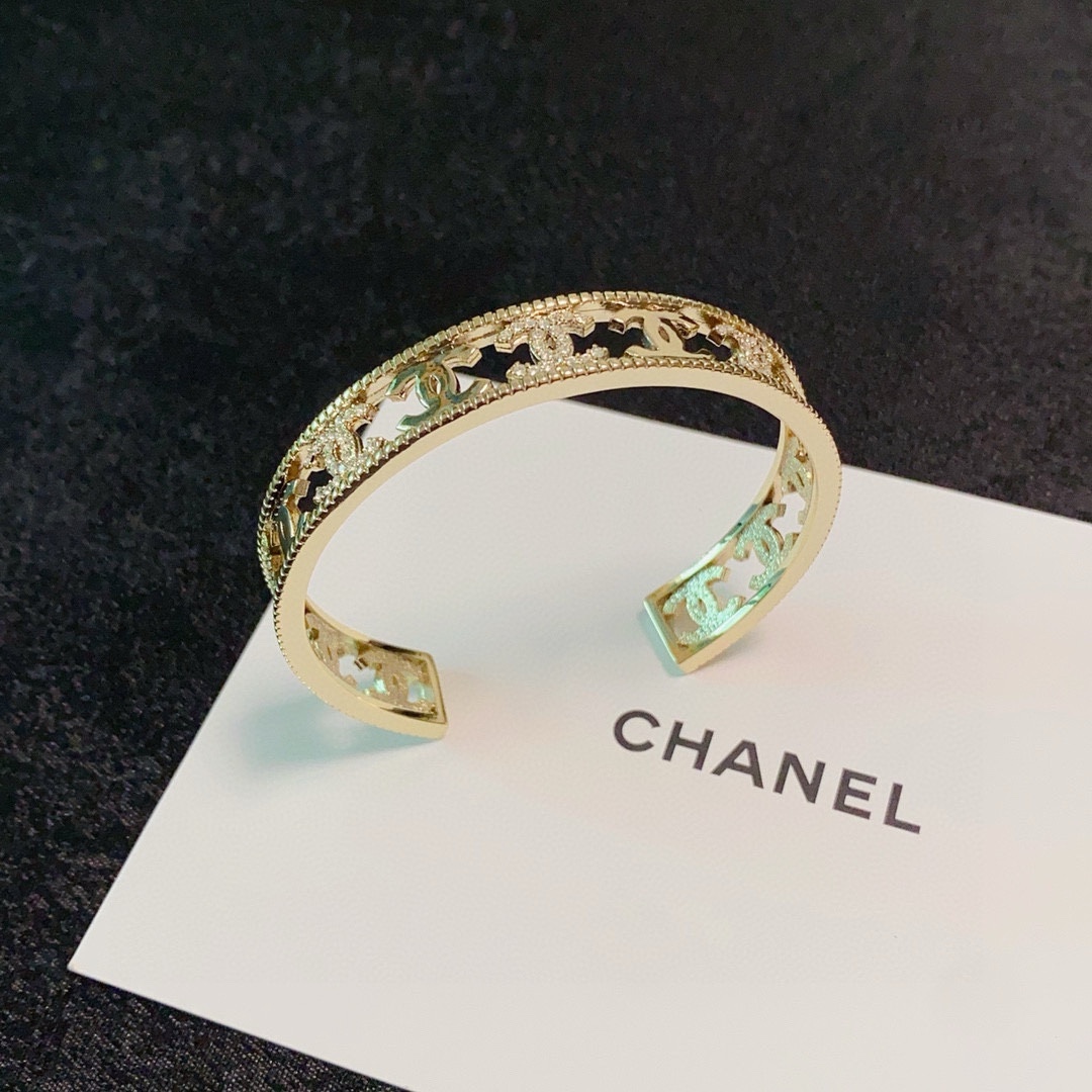Chanel CC Logo Crystal Cutout Cuff bracelet gold-tone metal with clear crystal accents 17cm inner circumference
