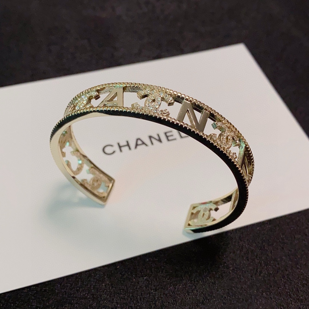 Chanel CC Logo Crystal Cutout Cuff bracelet gold-tone metal with clear crystal accents 17cm inner circumference