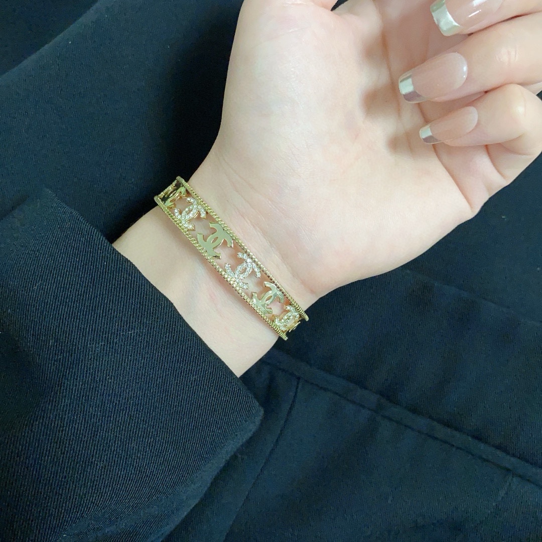 Chanel CC Logo Crystal Cutout Cuff bracelet gold-tone metal with clear crystal accents 17cm inner circumference