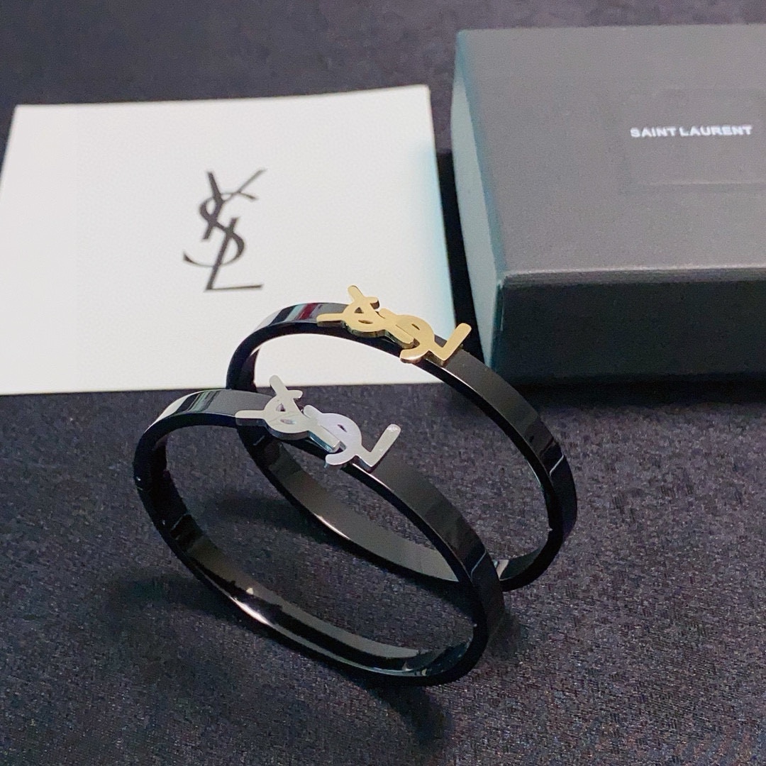 Saint Laurent Cassandre YSL Monogram Bangle bracelet Black polished metal band with gold-tone or silver-tone YSL logo hardware 17cm inner circumference