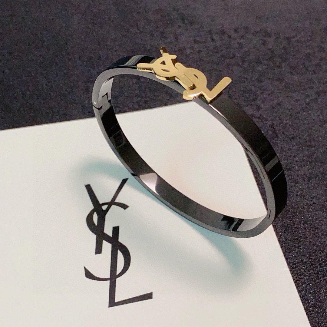 Saint Laurent Cassandre YSL Monogram Bangle bracelet Black polished metal band with gold-tone or silver-tone YSL logo hardware 17cm inner circumference