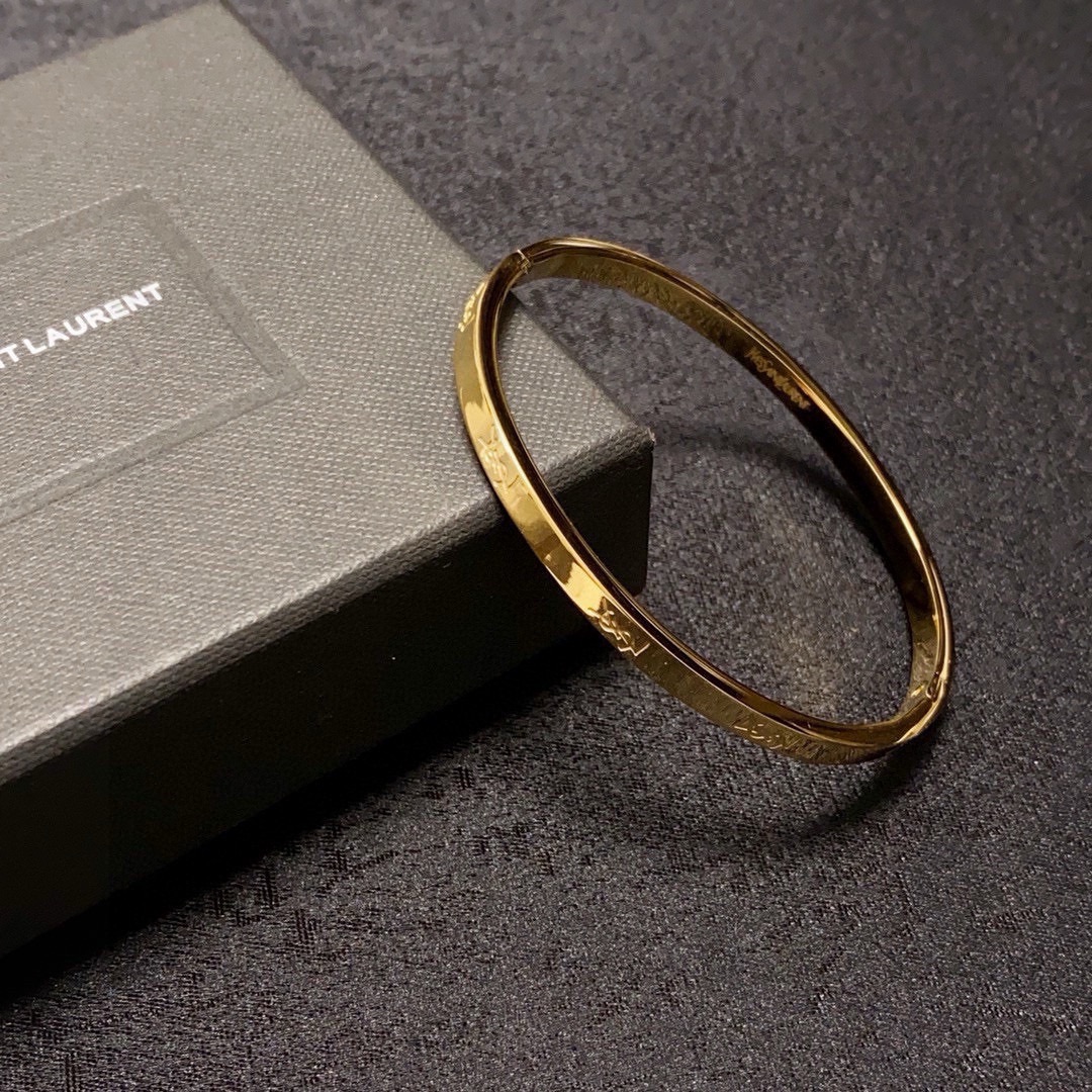 Saint Laurent Cassandre Logo Engraved Bangle bracelet gold-tone metal no accent stones 17cm inner circumference