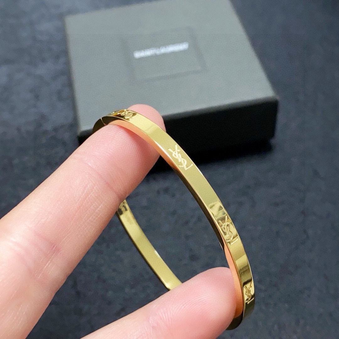 Saint Laurent Cassandre Logo Engraved Bangle bracelet gold-tone metal no accent stones 17cm inner circumference