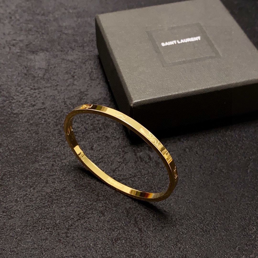 Saint Laurent Cassandre Logo Engraved Bangle bracelet gold-tone metal no accent stones 17cm inner circumference