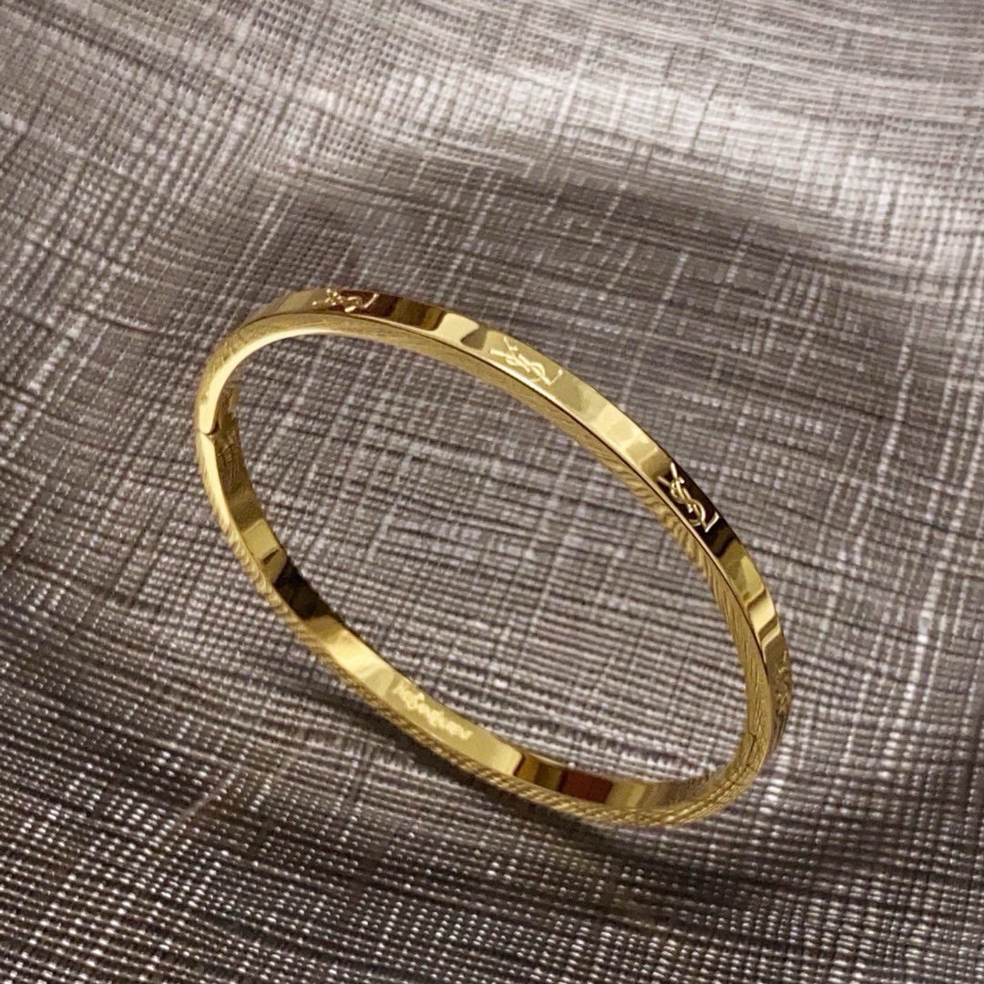 Saint Laurent Cassandre Logo Engraved Bangle bracelet gold-tone metal no accent stones 17cm inner circumference