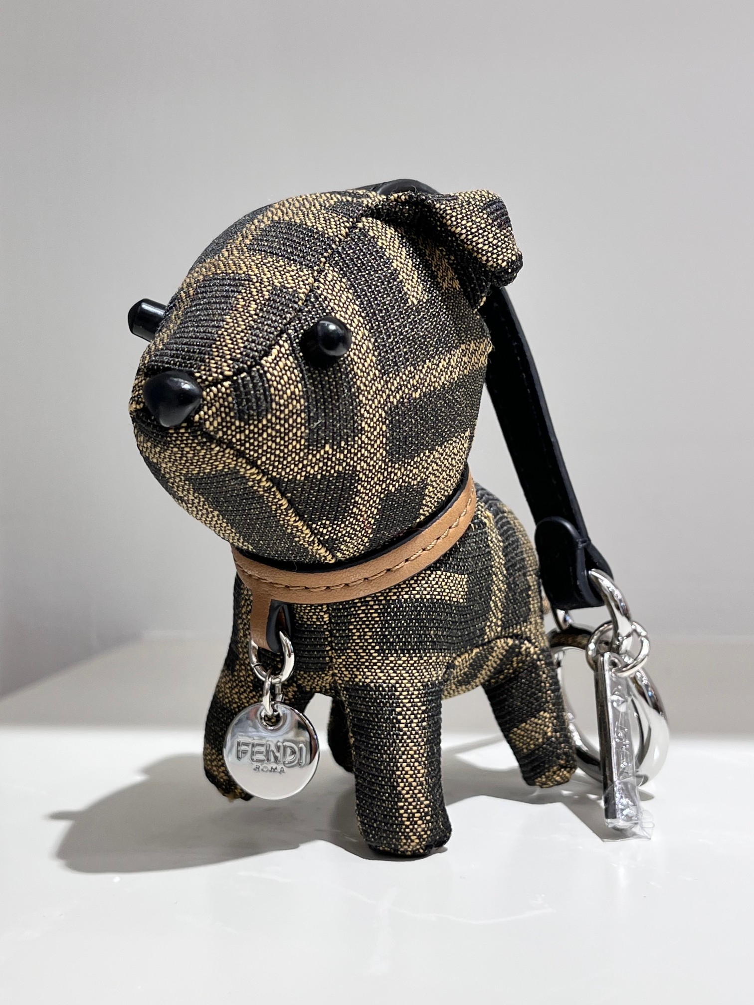 Fendi FF Monogram Puppy Bag Charm pendant Tobacco brown and black FF jacquard fabric tan leather collar silver-tone metal hardware black leather strap black plastic accents 10cm charm with 8cm