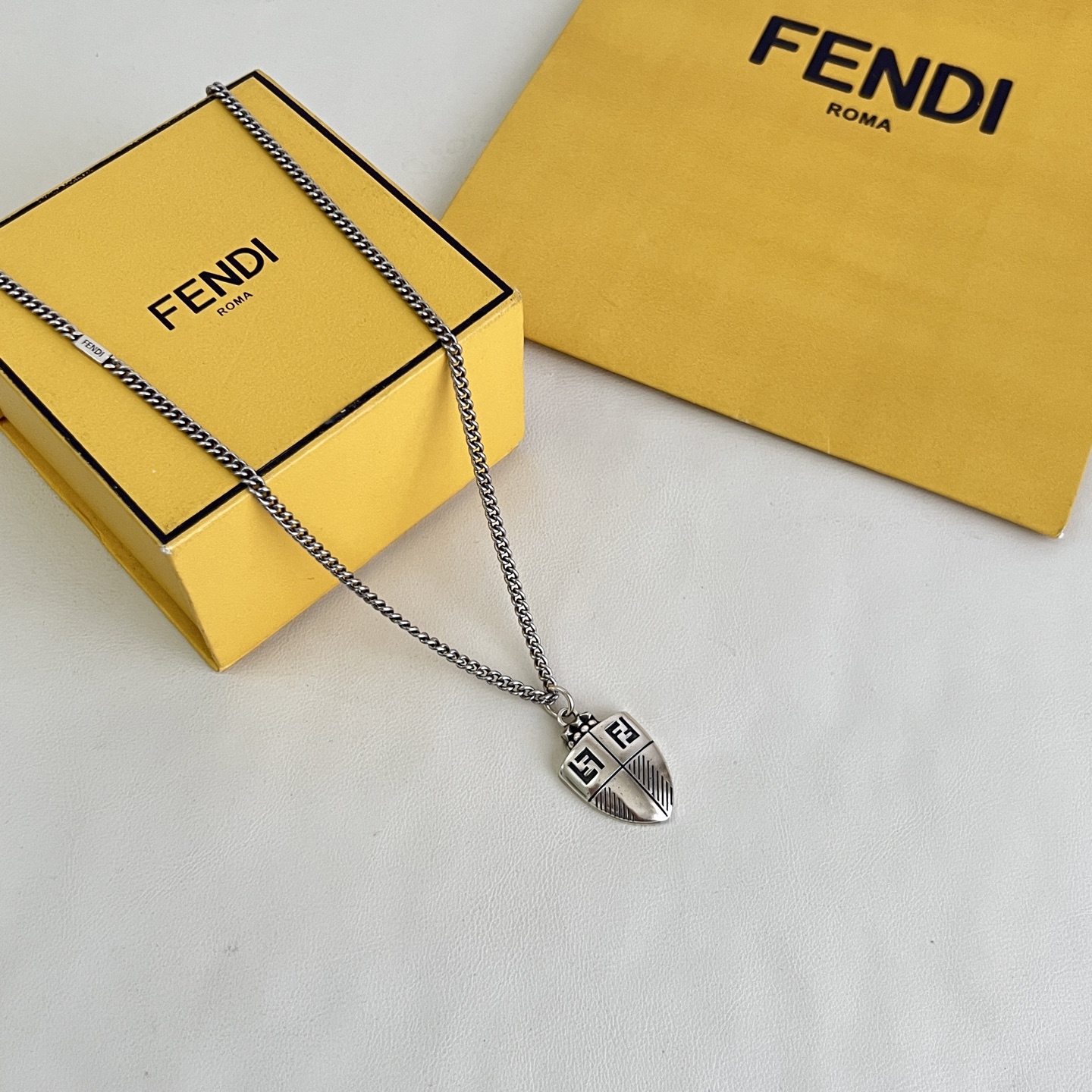 Fendi FF Shield Pendant necklace antique silver-tone metal with black enamel FF logo detailing 50cm