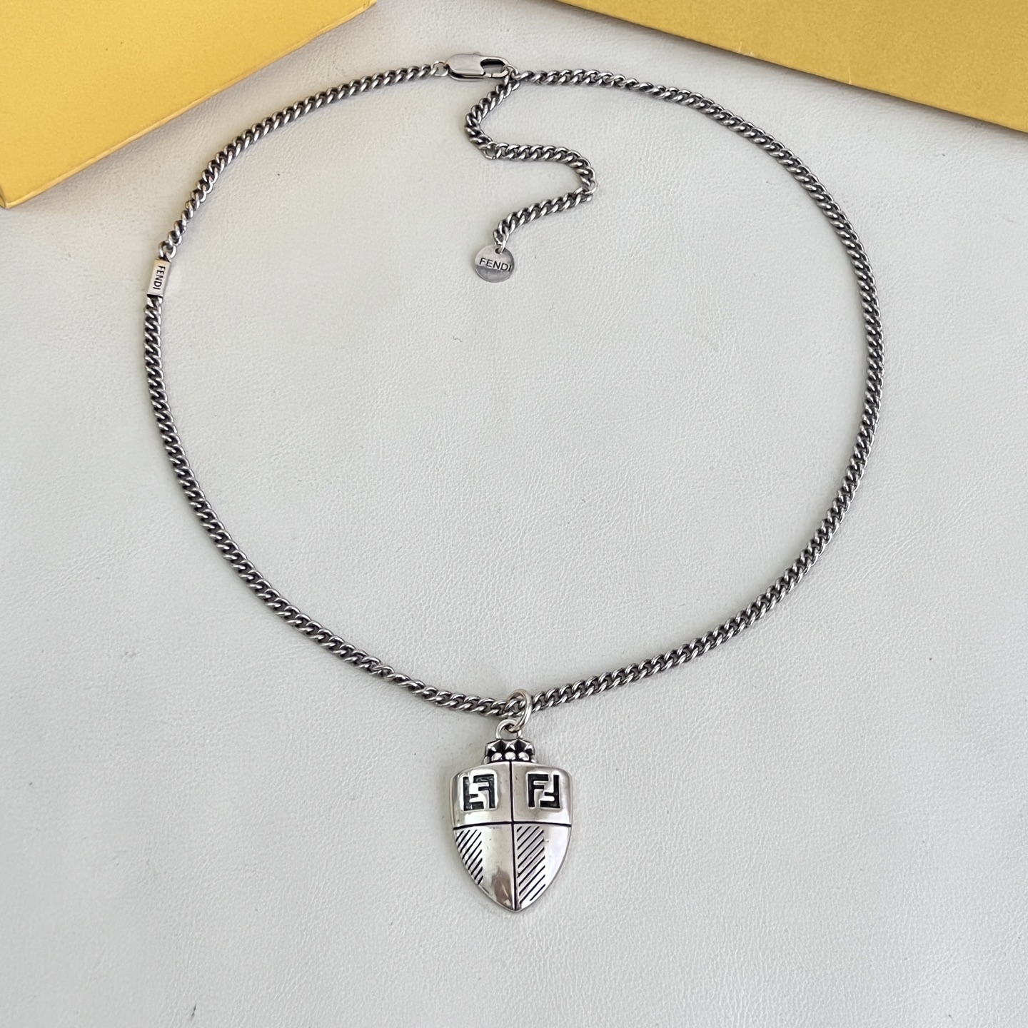 Fendi FF Shield Pendant necklace antique silver-tone metal with black enamel FF logo detailing 50cm