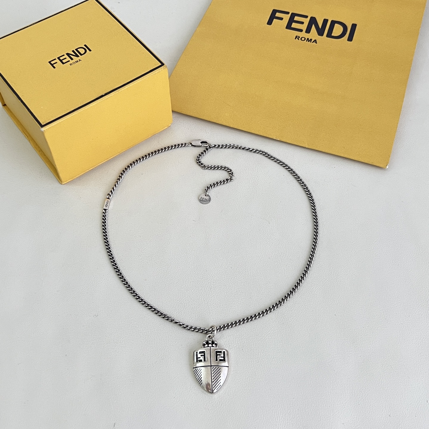 Fendi FF Shield Pendant necklace antique silver-tone metal with black enamel FF logo detailing 50cm