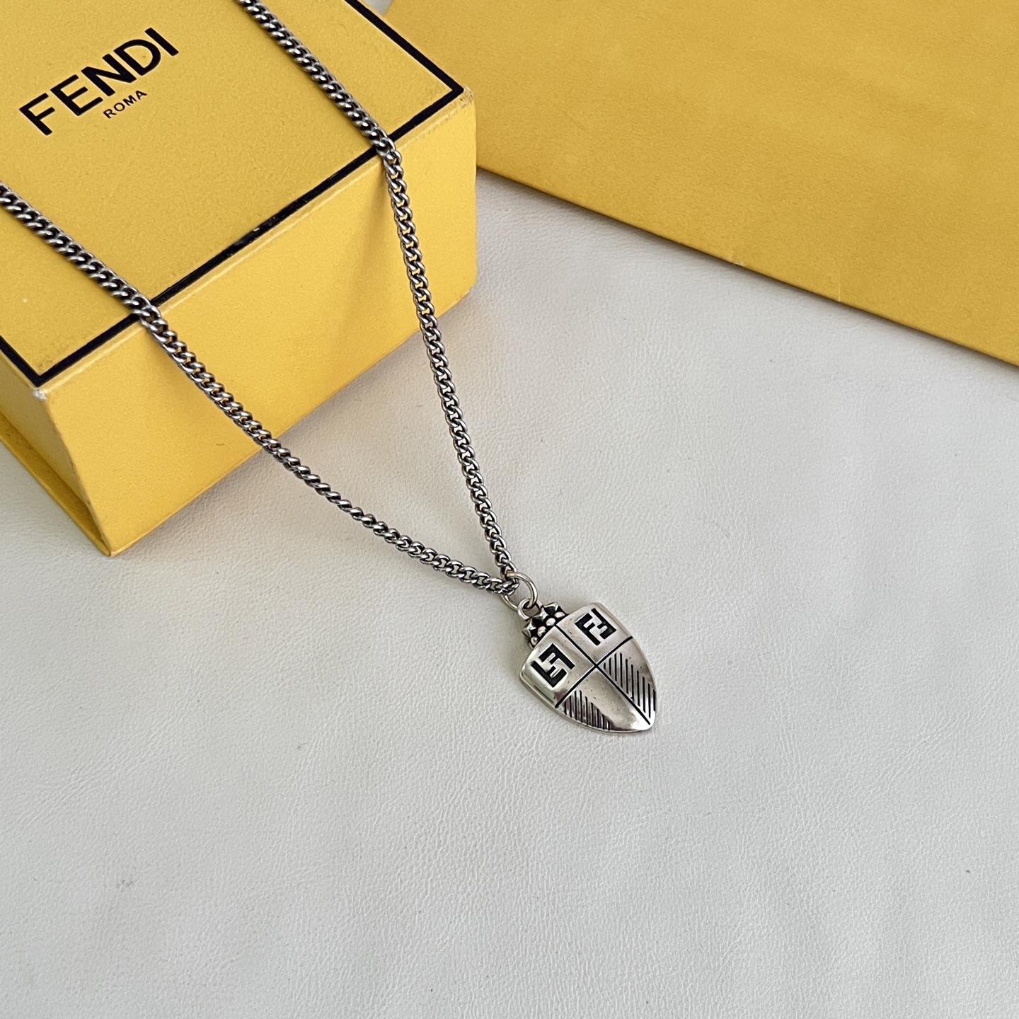 Fendi FF Shield Pendant necklace antique silver-tone metal with black enamel FF logo detailing 50cm