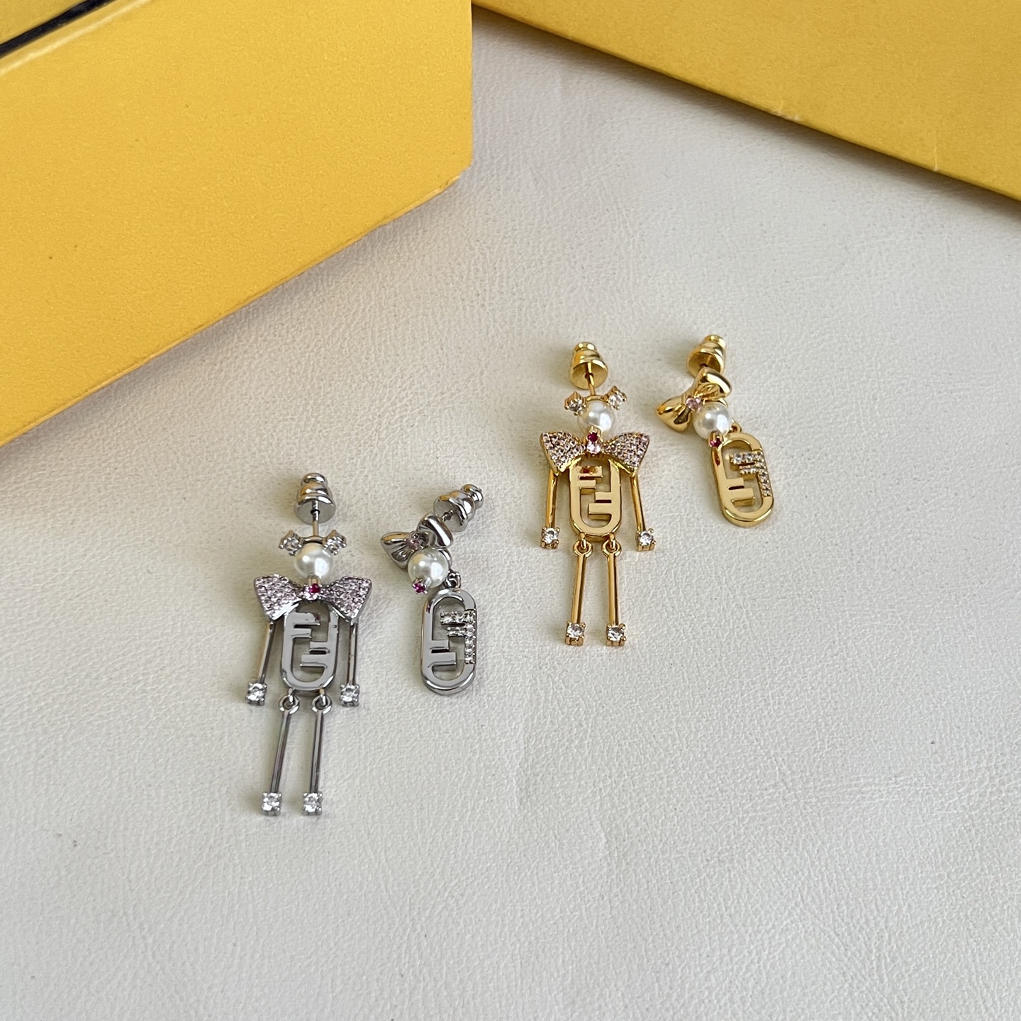 Fendi FF Robot Asymmetric Earrings earrings Available in two variants gold-tone metal with white faux pearl clear pave crystals and pink accent stone silver-tone metal with white faux pearl clear pave crystals and pink accent stone One Size drop length approx 3 5cm