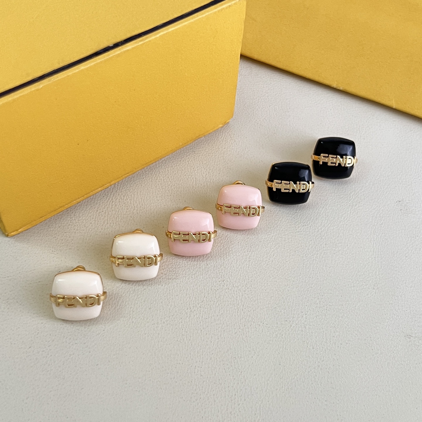 Fendi Fendi Logo Cushion Stud Earrings earrings Gold-tone metal with white pink or black resin accents 1cm stud diameter